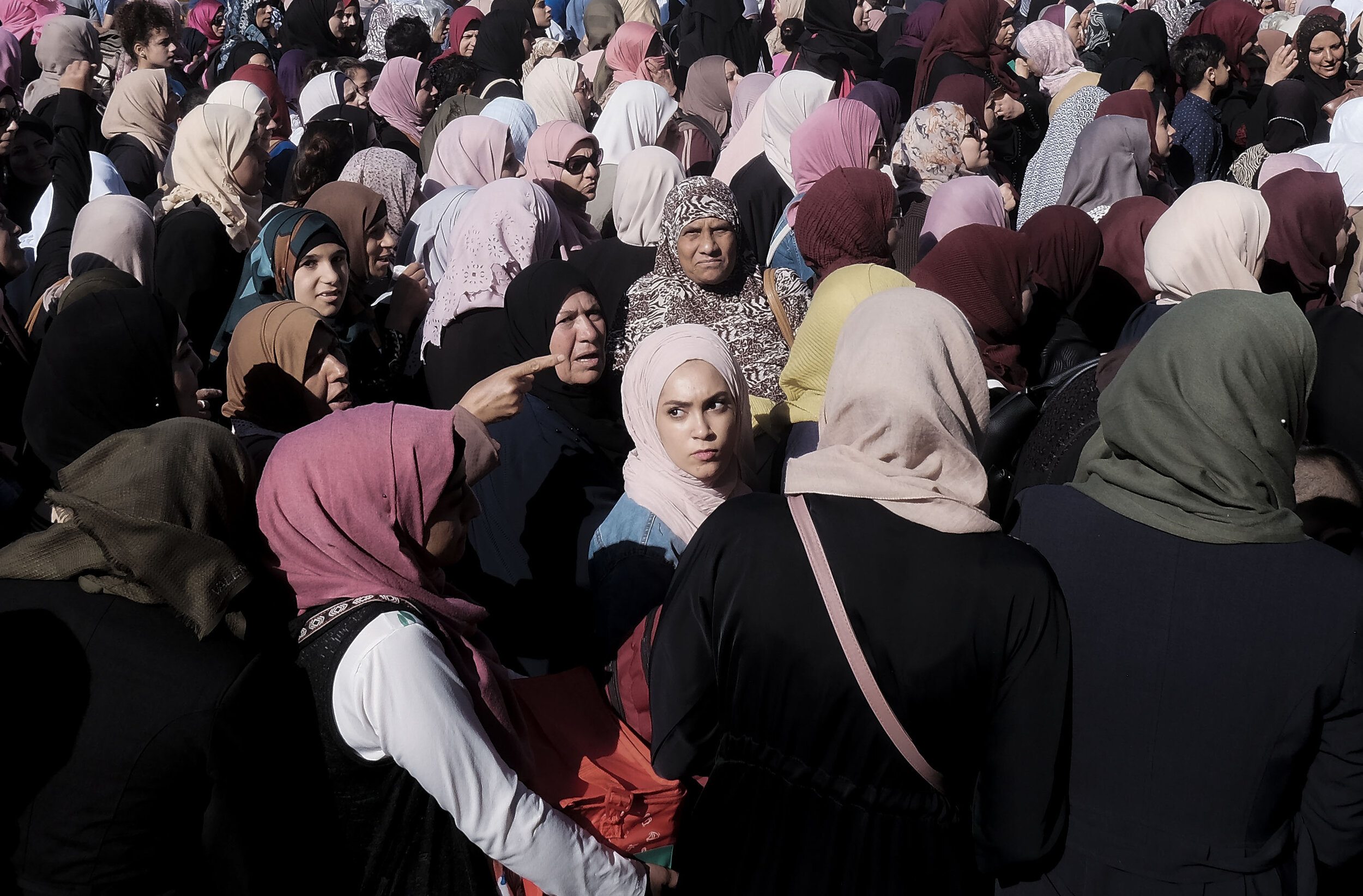  A Palestinian woman waits in a sea of other Palestinians to cross Qalandia Checkpoint which separates Israel from the Occupied West Bank. Each day millions cross through the checkpoint to work, visit relatives, or attend prayer at Al Aqsa Mosque in 