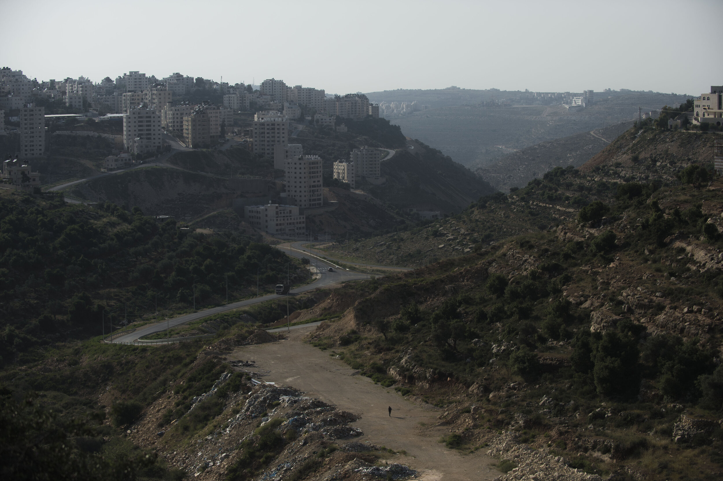  A man walks through the valley that cuts in Ramallah, the de facto capital of the Occupied West Bank. 