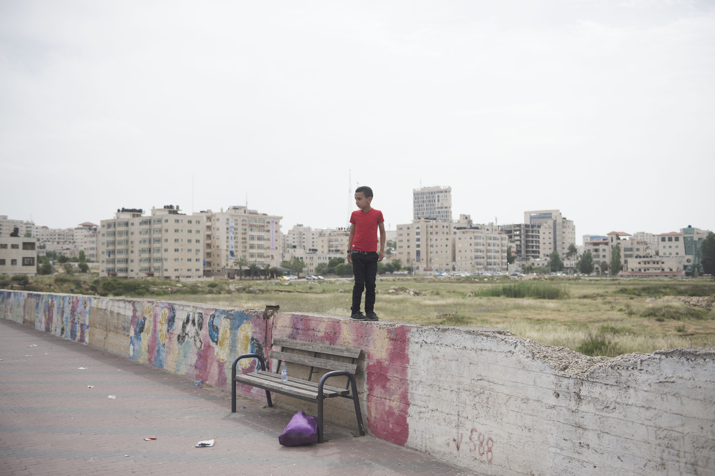  A child plays by himself on an empty street in the hours before heavy clashes between Israeli troops and Palestinian protesters erupt in Beit-El in the Occupied West Bank. 