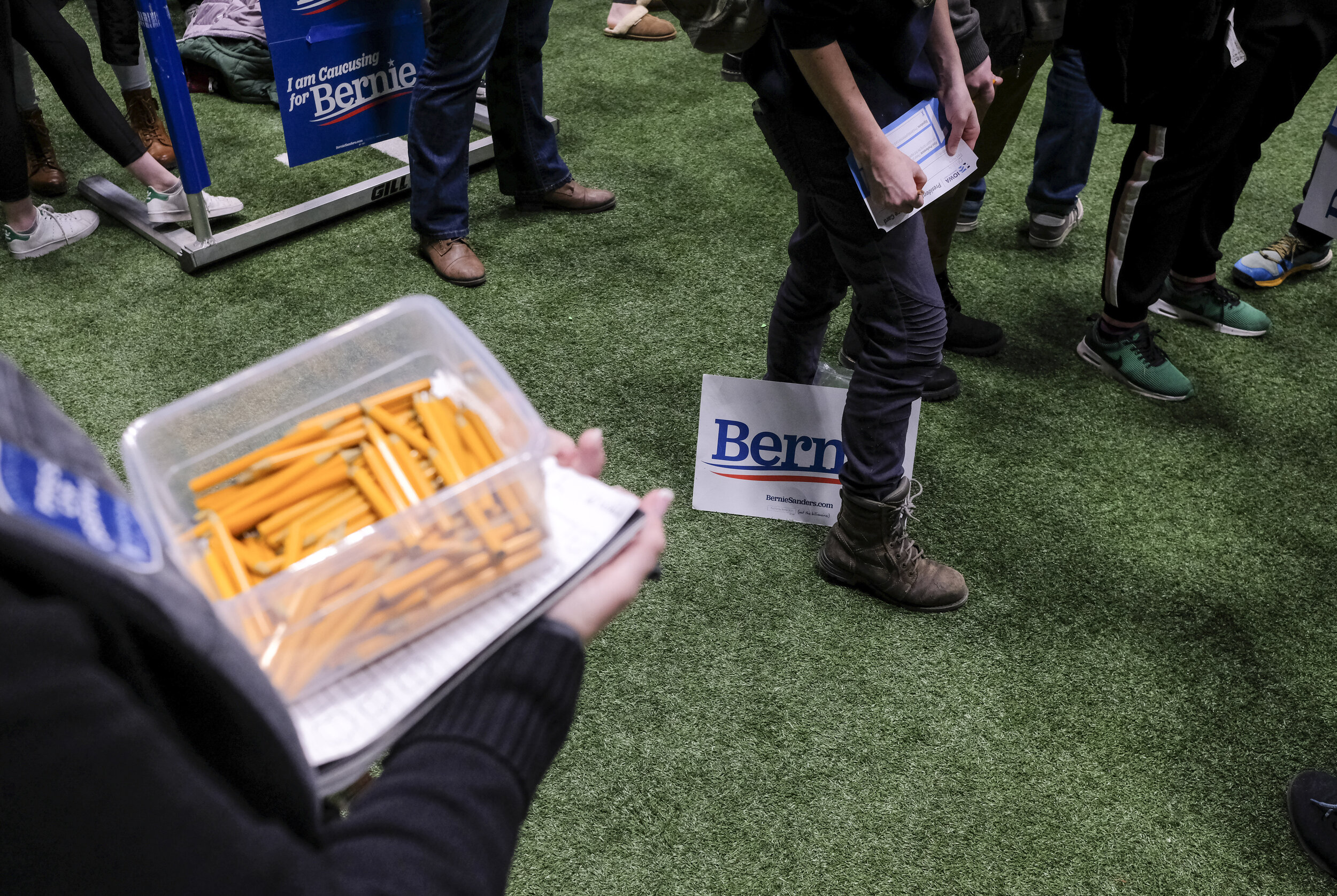  Voters casting their ballots for Bernie Sanders gathered together and fill out forms on Iowa Caucus night at Drake University in Des Moines, Iowa on February 3, 2020. 