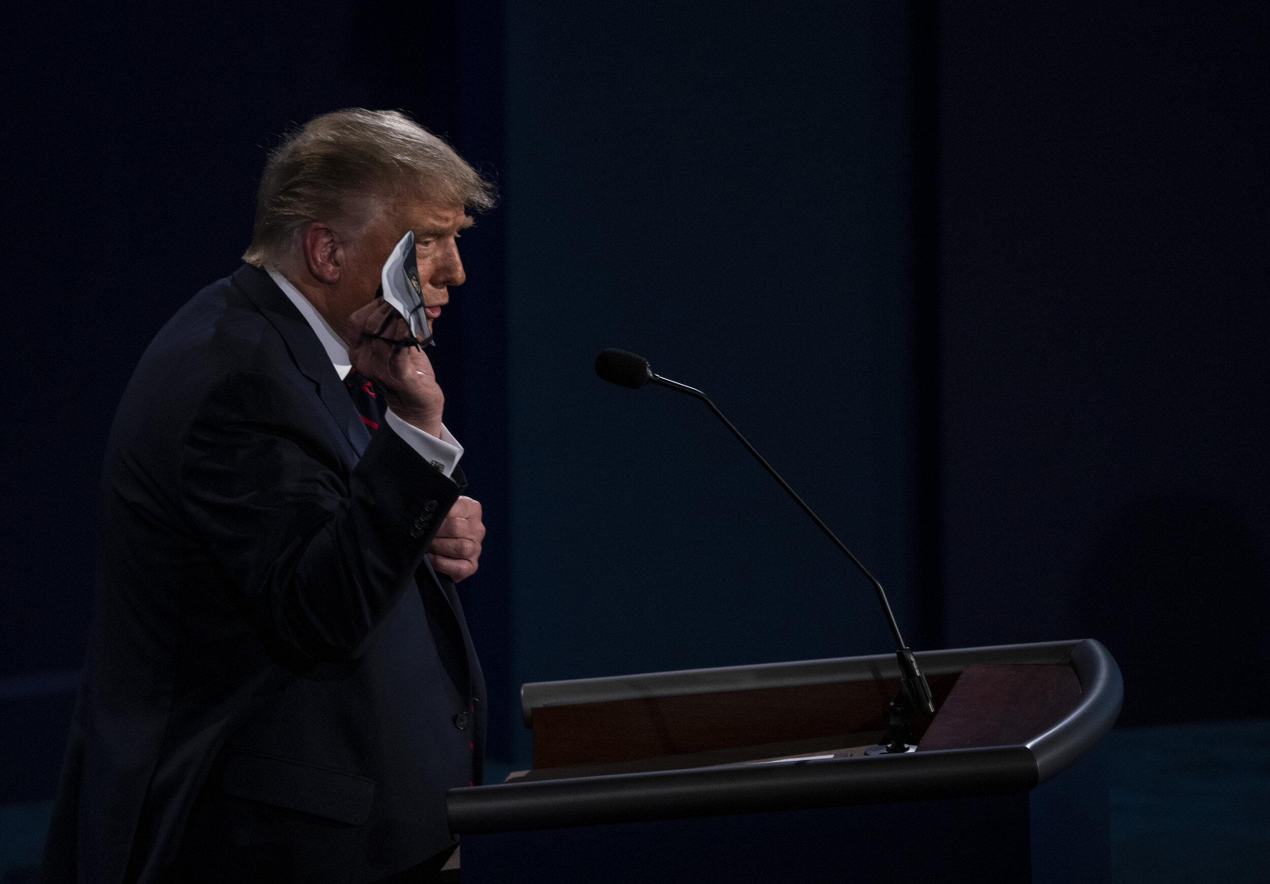 President Donald Trump holds up his facemask while criticizing his opponent, former Vice President Joe Biden, for not holding rallies and for always attending public appearances with a mask during the first presidential debate held at Case Western U