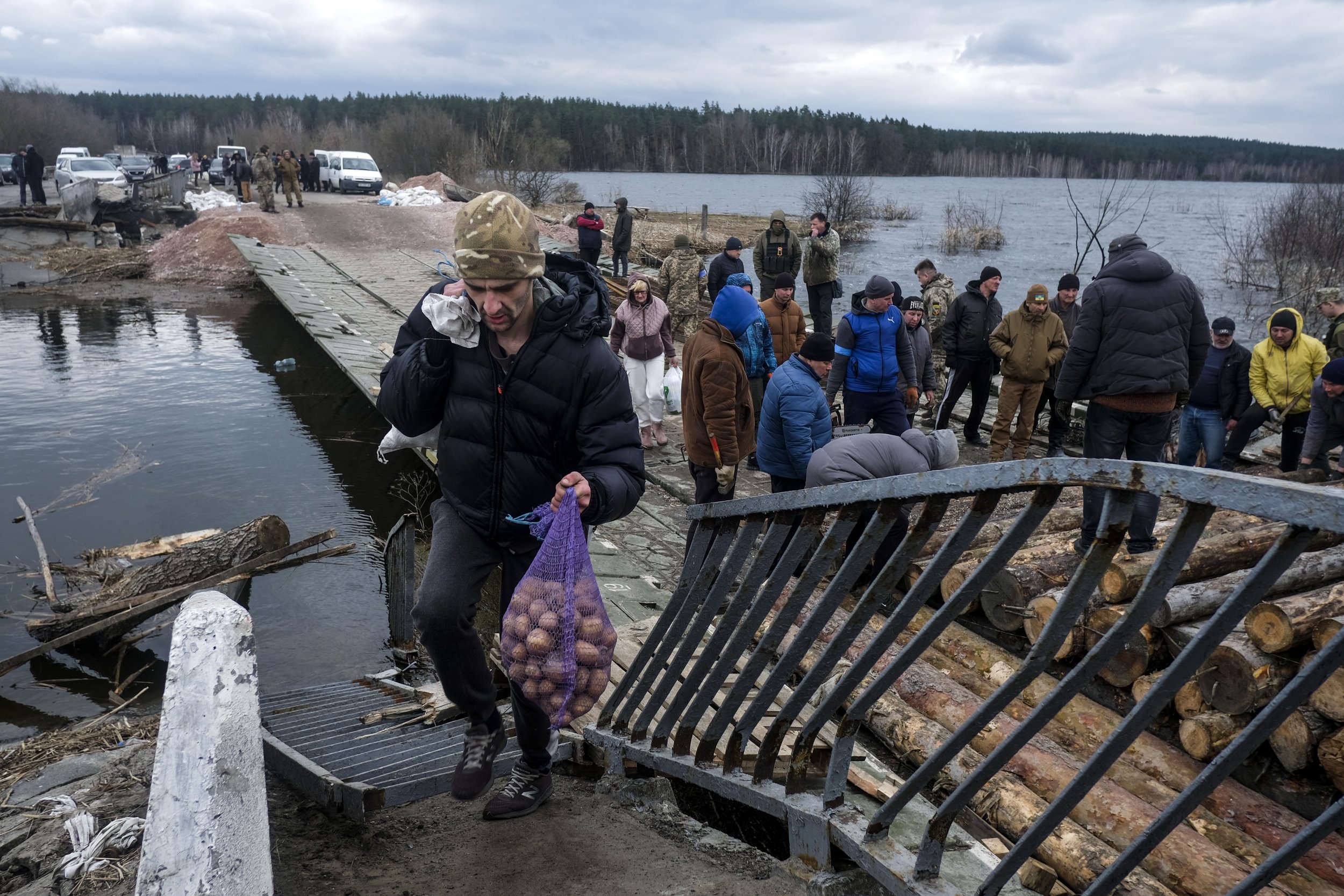  Civilians return to the flooded town of Demidiv, Ukraine after Ukrainian forces pushed out Russian troops from the Kyiv region on April 5, 2022. Heavy fighting during the battle of Kyiv destroyed many of the towns and villages surrounding the capita
