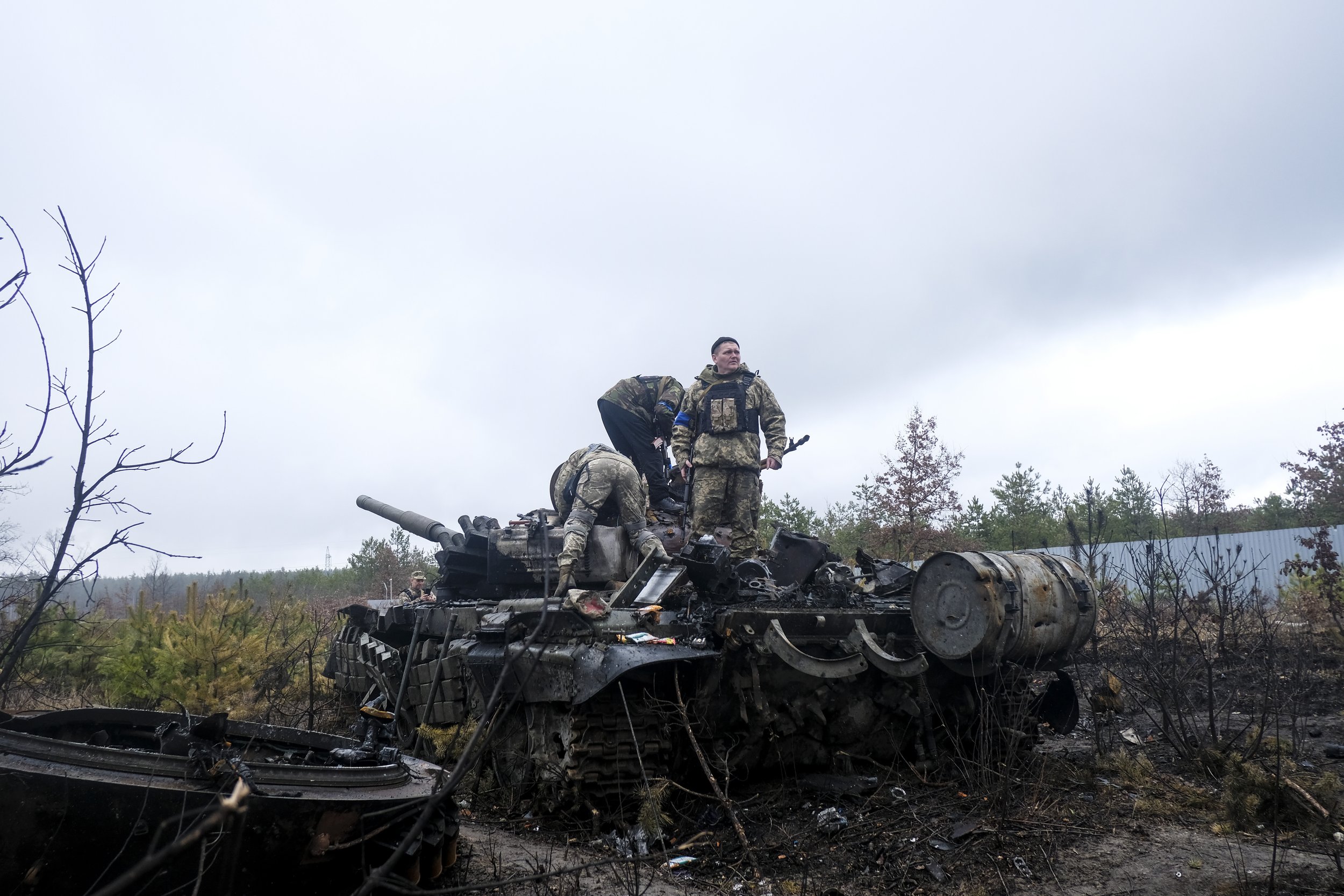  Ukrainian soldiers strip a Russian tank following an ambush that wiped out a column of Russian armored vehicles on April 3, 2022. Well-placed ambushes, javelins, and Ukrainian knowledge of the area eventually forced Russian troops to withdraw from t