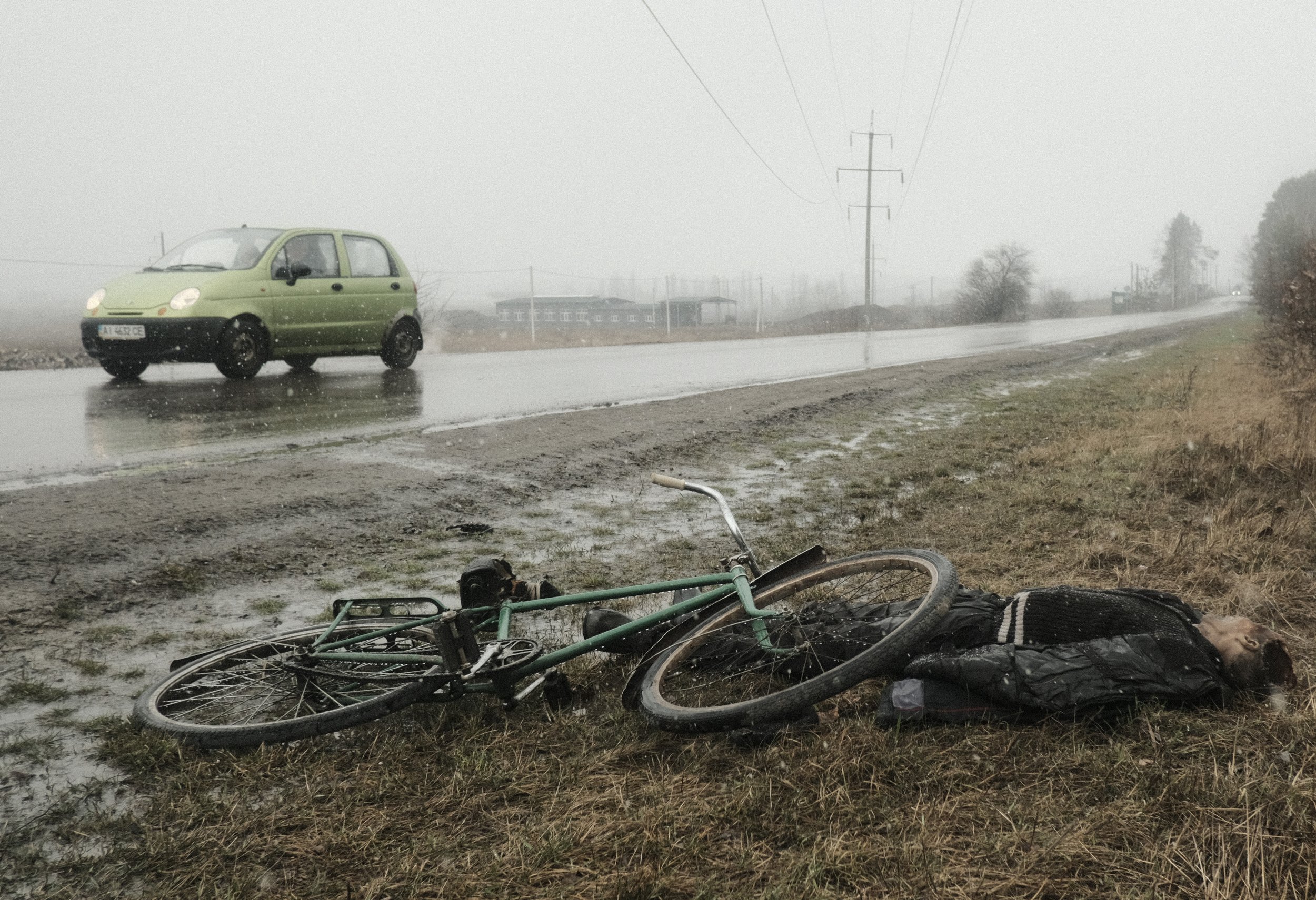  The body of a Ukrainian civilian lies next to his bicycle where he fell on the side of a road near Bucha, Ukraine on April 3, 2022. After Ukrainian forces liberated the villages and towns surrounding Kyiv, mass graves and the bodies of civilians wer