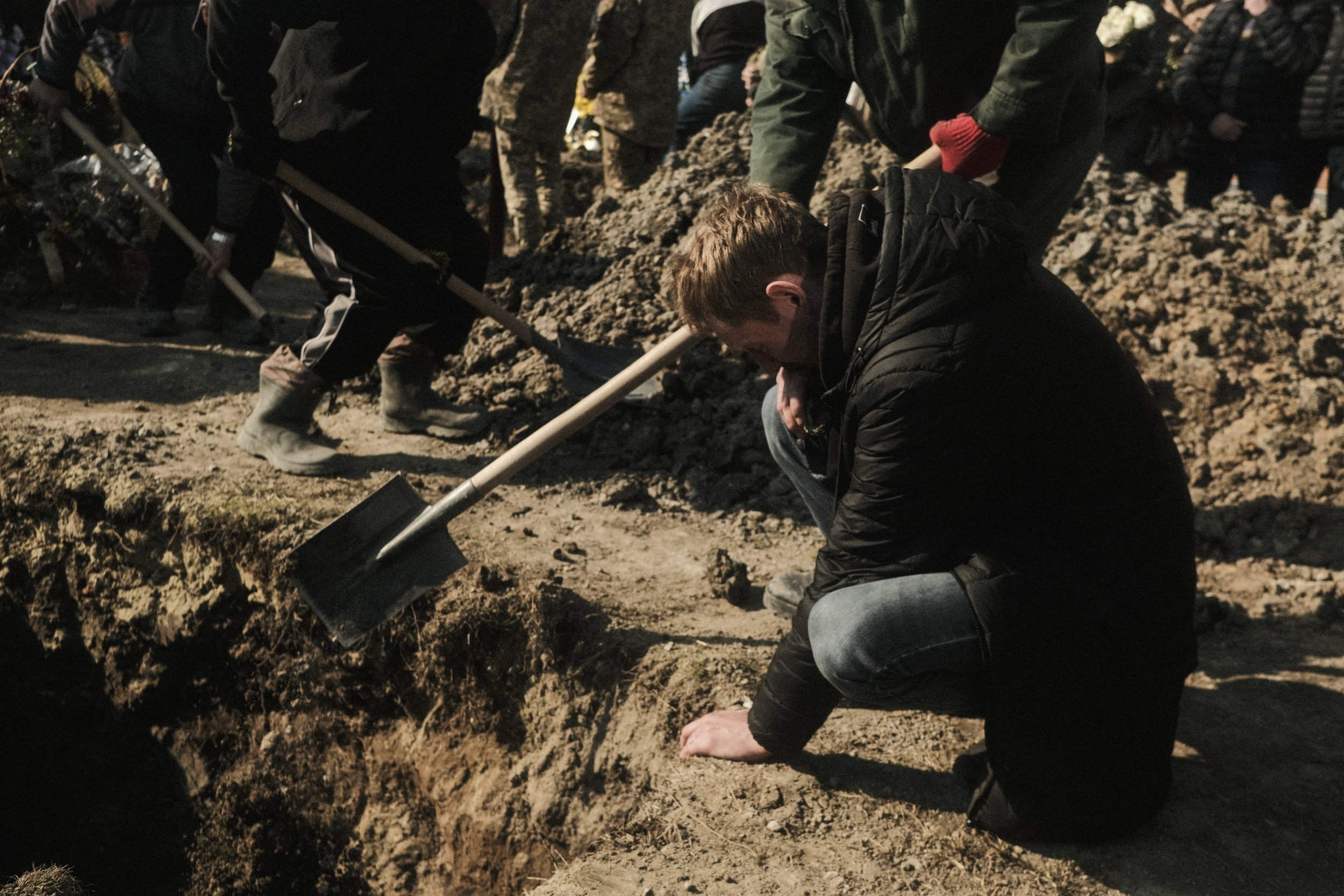  A man weeps by the grave of his brother who was killed by a Russian missile strike on Lviv, Ukraine on March 11, 2022. Despite Lviv being in the far western part of the country, Russian missile and drone attacks continue to claim casualties in areas