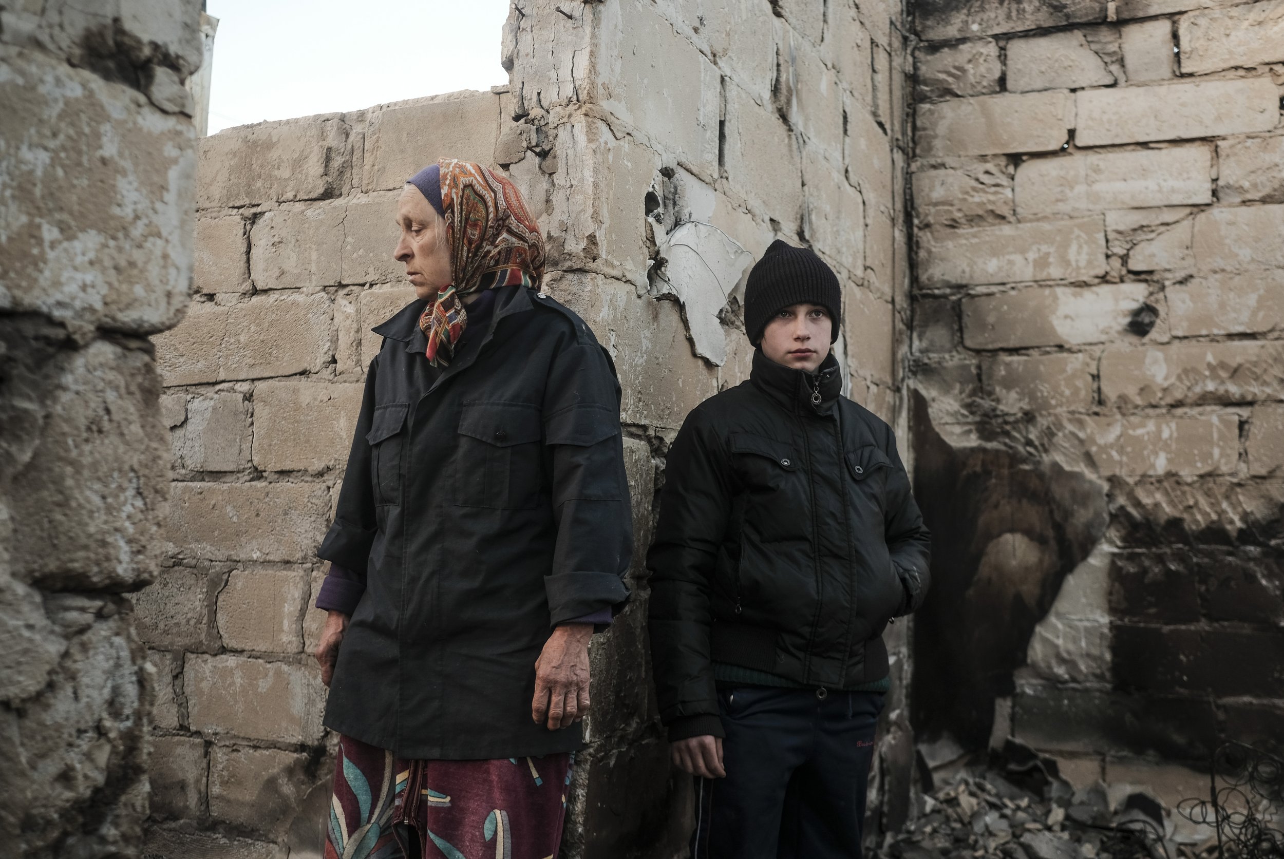  A woman and her grandson stand in the ruins of their home in Chernihiv, Ukraiine on April 15, 2022. Chernihiv, a city in the northeast of Ukraine saw heavy fighting which destroyed much of the city and its infrastructure leaving many without homes, 