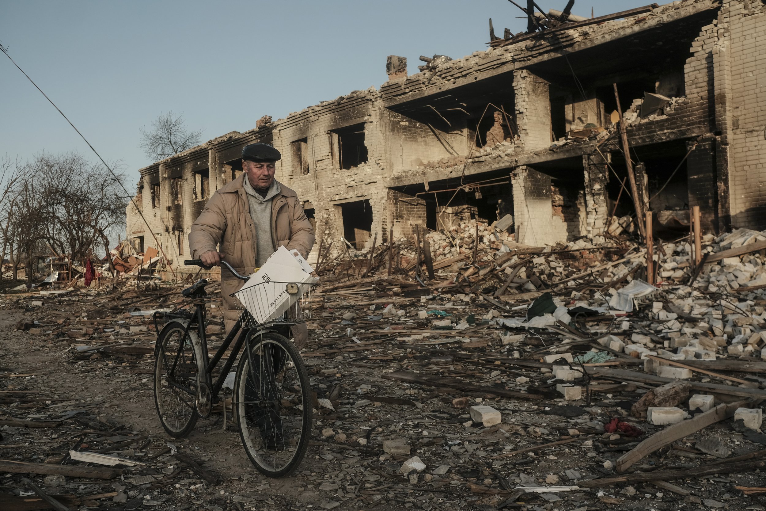  A man walks his bike through a destroyed neighborhood in Chernihiv, Ukraine on April 14, 2022. Chernihiv, a city in northeast Ukraine saw massive destruction amid heavy fighting leaving the city without electricity or access to basic necessities. 