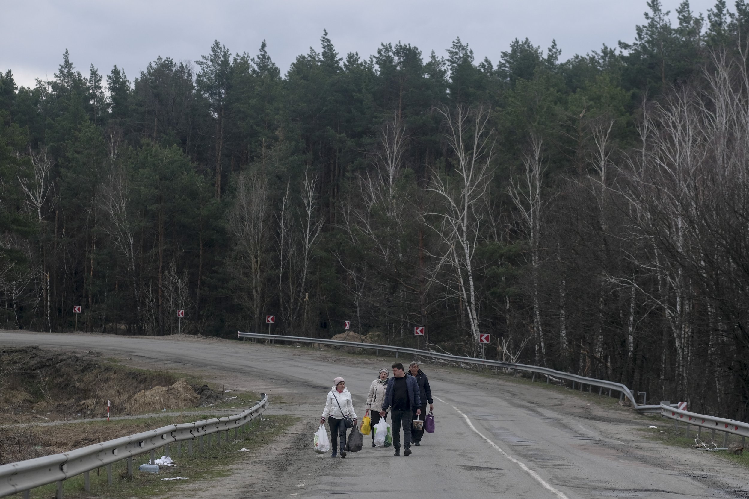  Civilians walk the long road towards Demydiv following Russian troops’ retreat back to Belarus on April 5, 2022. After Russian forces pulled out of Kyiv Oblast, Ukrainian civilians began to return to the homes they had fled at the outbreak of the in