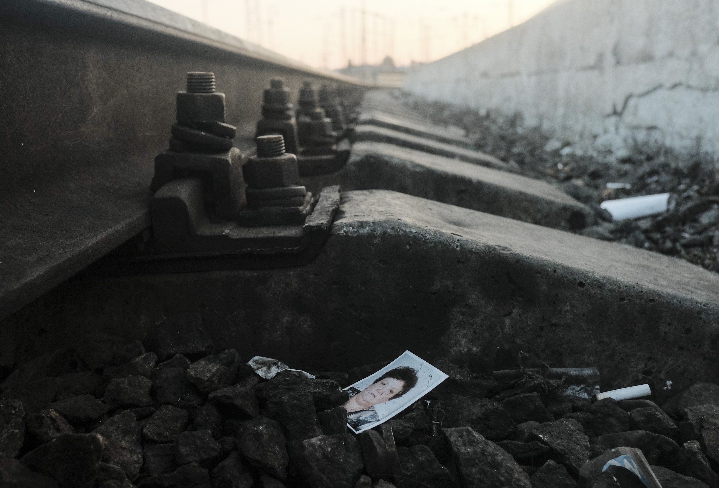  A photograph of a woman on the railroad tracks of the Lviv-Holovnyi Railway Station in Lviv, Ukraine on March 11, 2022. As millions fled Ukraine at the start of the Russian invasion many lost or left behind belongings at the railway stations.  