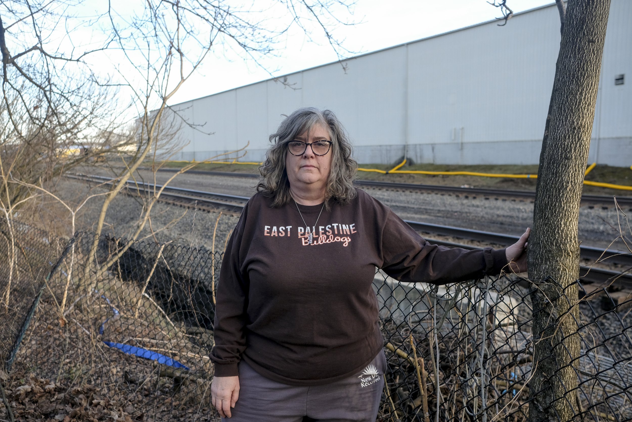  Brenda Foster poses for a portrait in her backyard that sits up against the rail road tracks at her home on East Clark Street in East Powell, Ohio on Saturday, February 18, 2023. Foster was one of hundreds of East Palestine residents evacuated from 