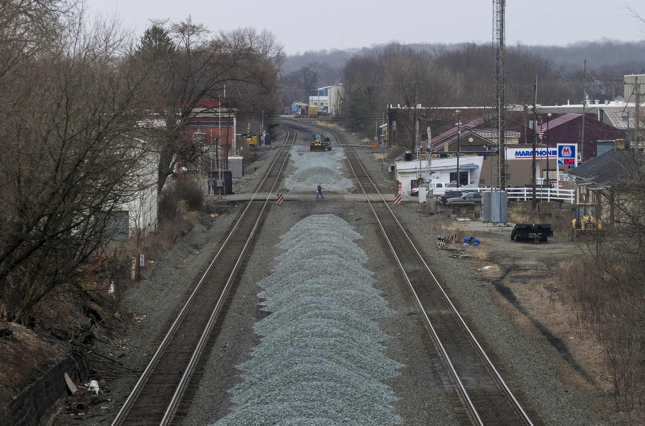  A man walks across the train tracks that run through East Palestine, Ohio on Friday, February 17, 2023. On February 3 a Norfolk Southern train derailed while carrying several cars containing toxic materials including Vinyl Phosphate. Following the d