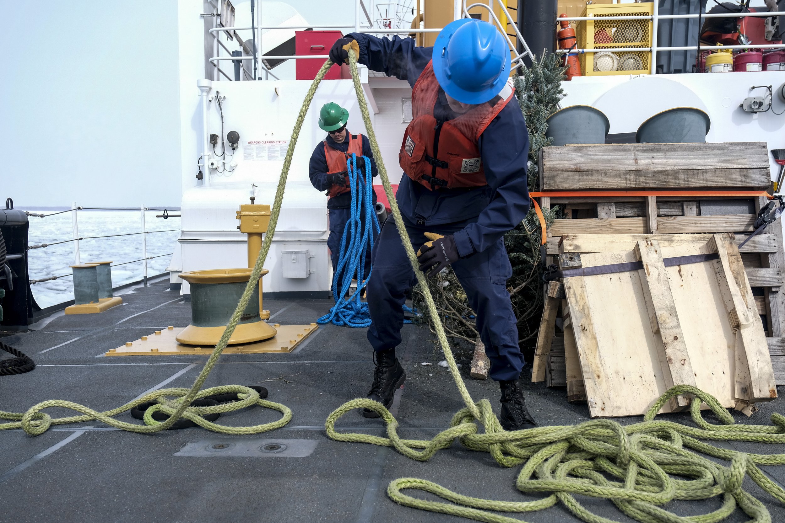  Crew members of the US Coast Guard Cutter Katmai Bay throw out lines and prepare to moor at Lime Island in near Lake Huron following a day of operations cutting ice in the St. Mary's River on Tuesday, March 14, 2023. The Katmai Bay is one of the shi