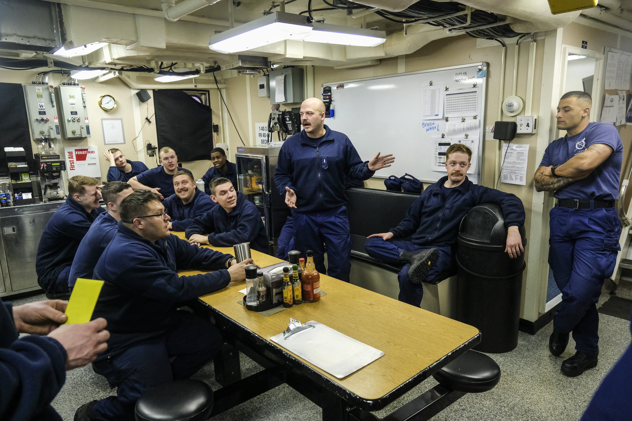  Executive Officer Bryant Giorgi speaks to crew members of the United States Coast Guard Cutter Katmai Bay following a day of operations cutting ice in the St. Mary's River on Tuesday, March 14, 2023. The Katmai Bay is one of the ships in the US Coas