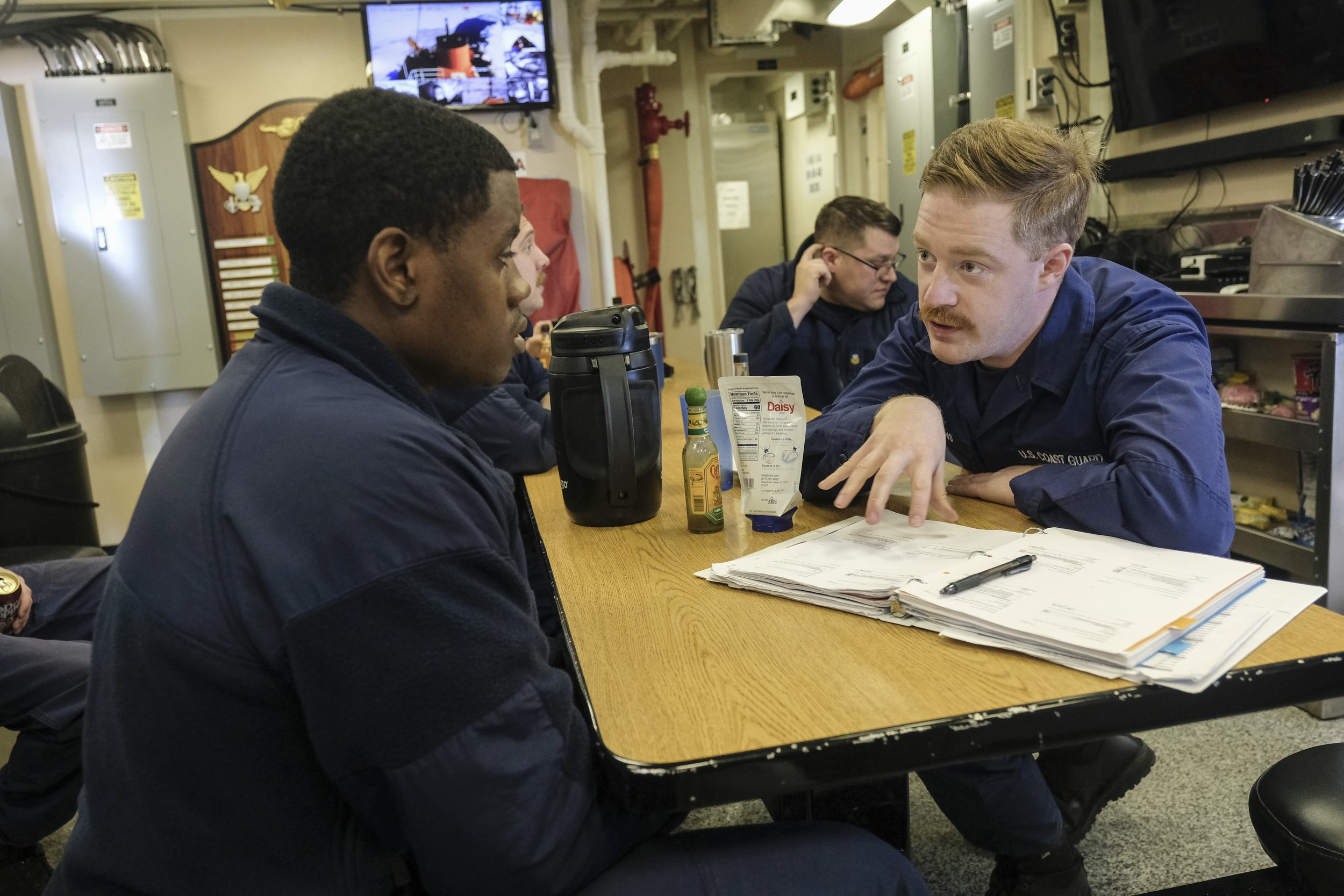  Seaman (SN) Tyler Hutchins helps SN Dayan R Caron Marcus study for a test about Damage Control while on an Ice Breaking operation in the St. Mary's River on Tuesday, March 14, 2023 aboard the US Coast Guard Cutter 'Katmai Bay;. The Katmai Bay is one
