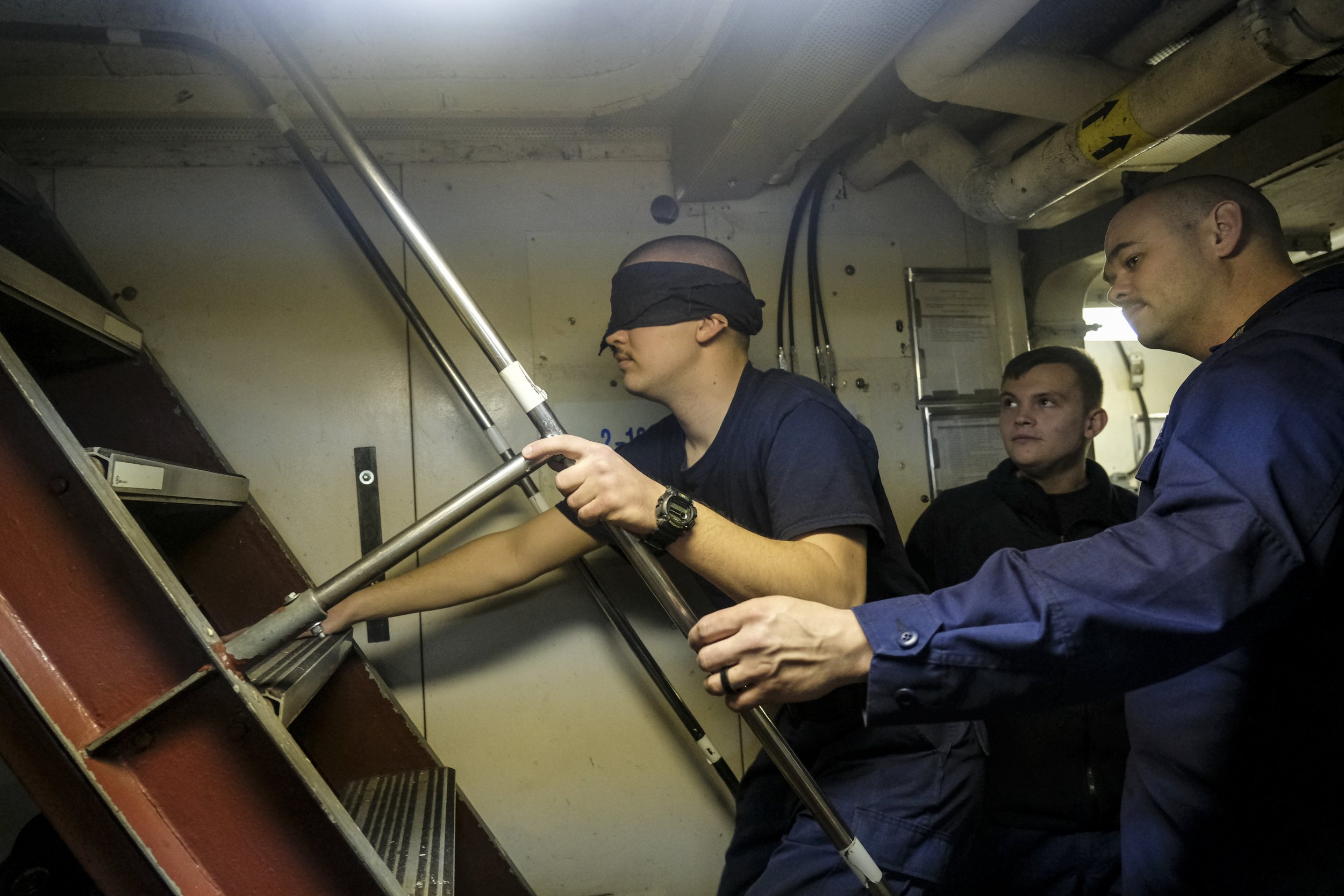  Engineer's Mate (EMC) Dawson Harris leads a blindfolded Seaman (SN) David Sherman through an evacuation drill during a lull in Ice Breaking operations aboard US Coast Guard Cutter  'Katmai Bay' to clear a Frozen  section of the St. Mary's river on M