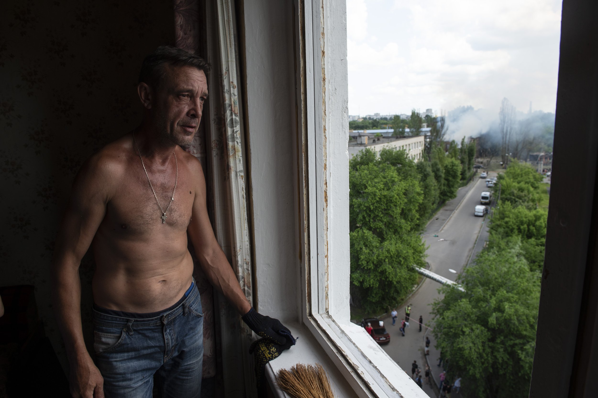  A Ukrainian man looks out over his street where a Russian missile struck a clinic and killed 6 in the morning in Dnipro, Ukraine on May 26, 2023. In Dnipro, multiple clinics and residential areas have continued to be targeted by Russian drones and m