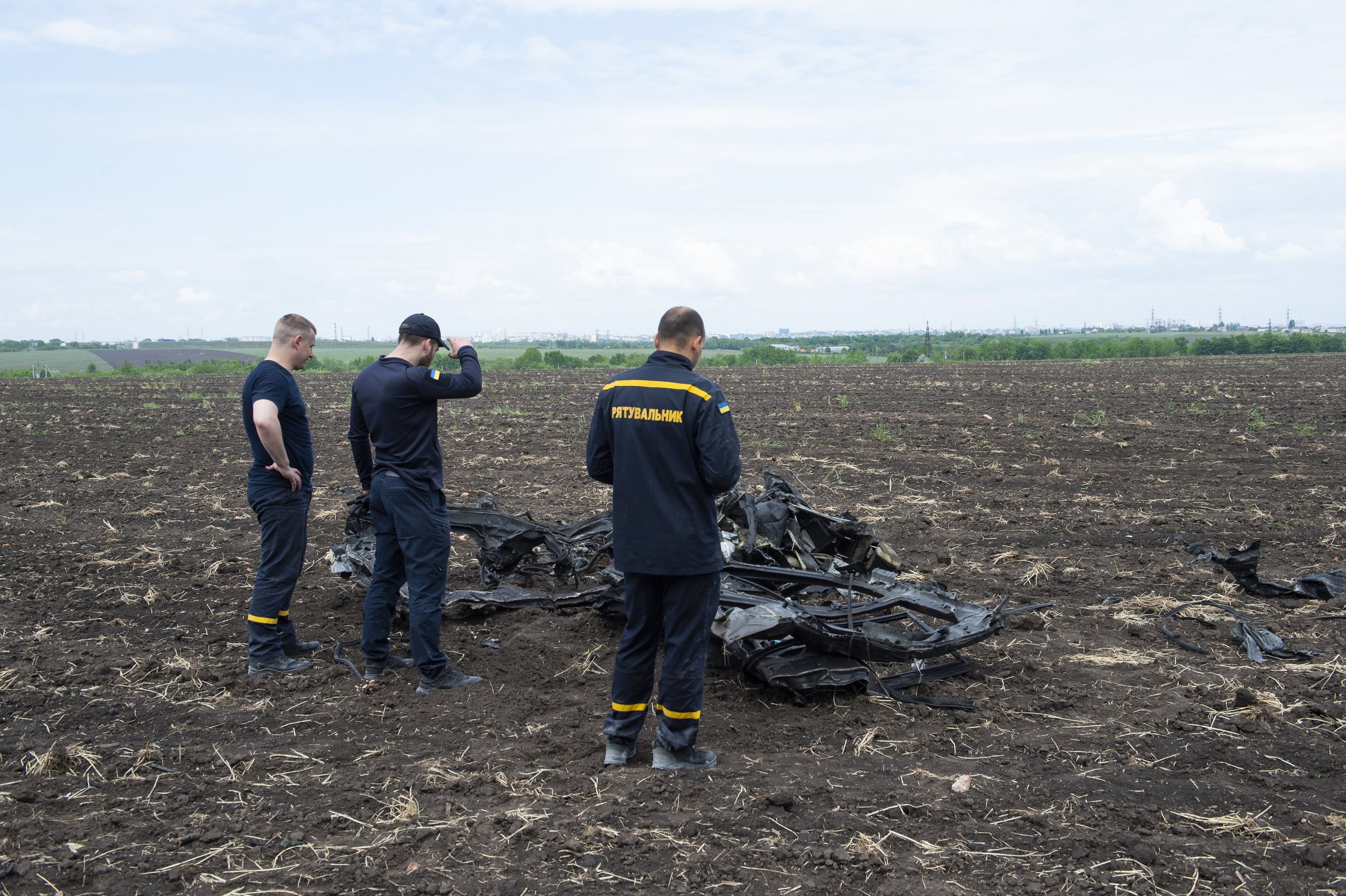  Emergency personnel investigate the remains of a destroyed car in a field in Dnipro, Ukraine on May 24, 2023. A Russian missile struck an emergency response center in Dnipro, destroying a number of ambulances and reserve medical equipment. 