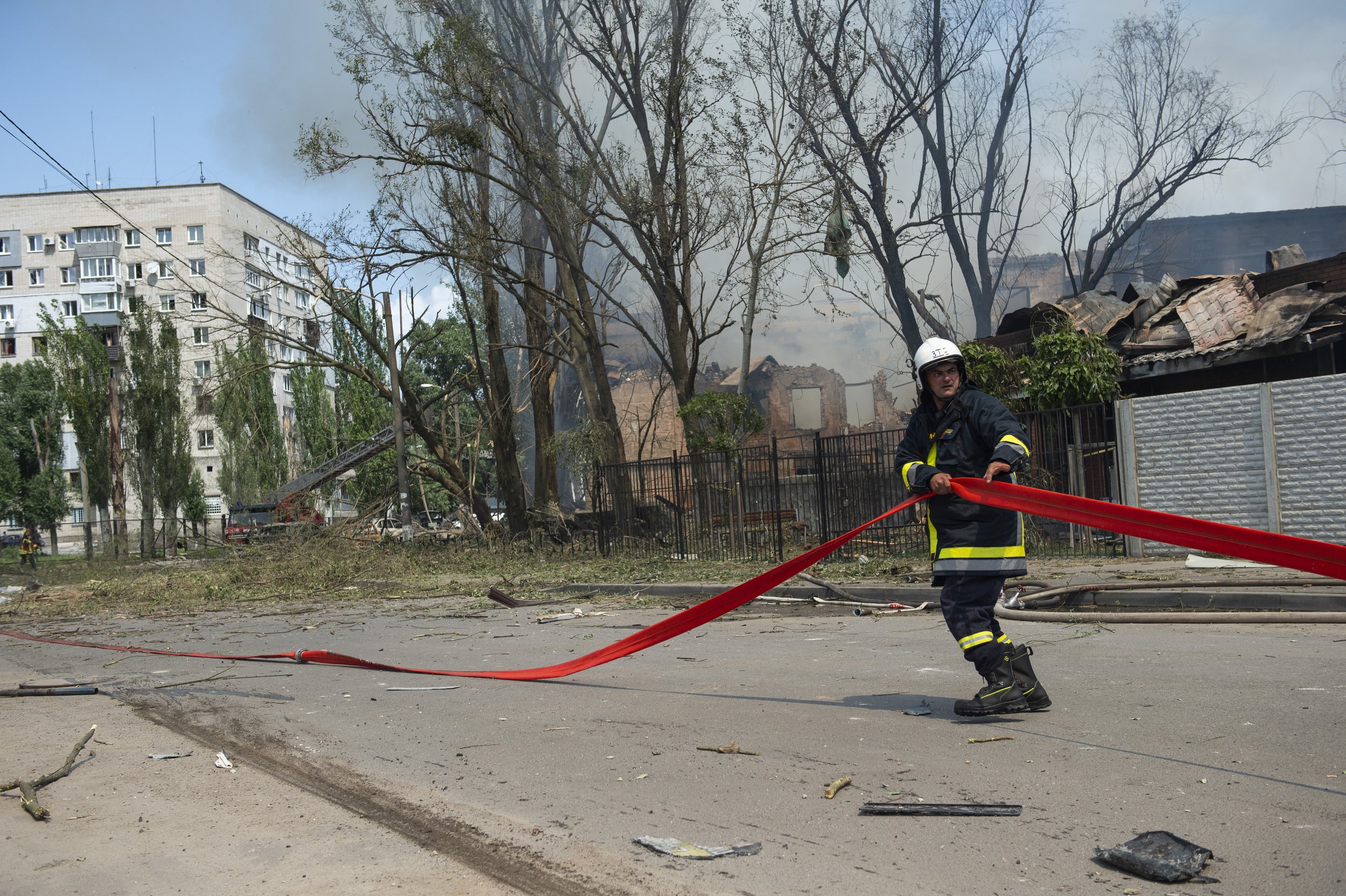  A firefighter runs with a hose towards the scene where a Russian missile struck a clinic in Dnipro killing 6 on May 26, 2023. Cities like Dnipro continue to be a prime target for the Russian military despite being far from the frontlines. 