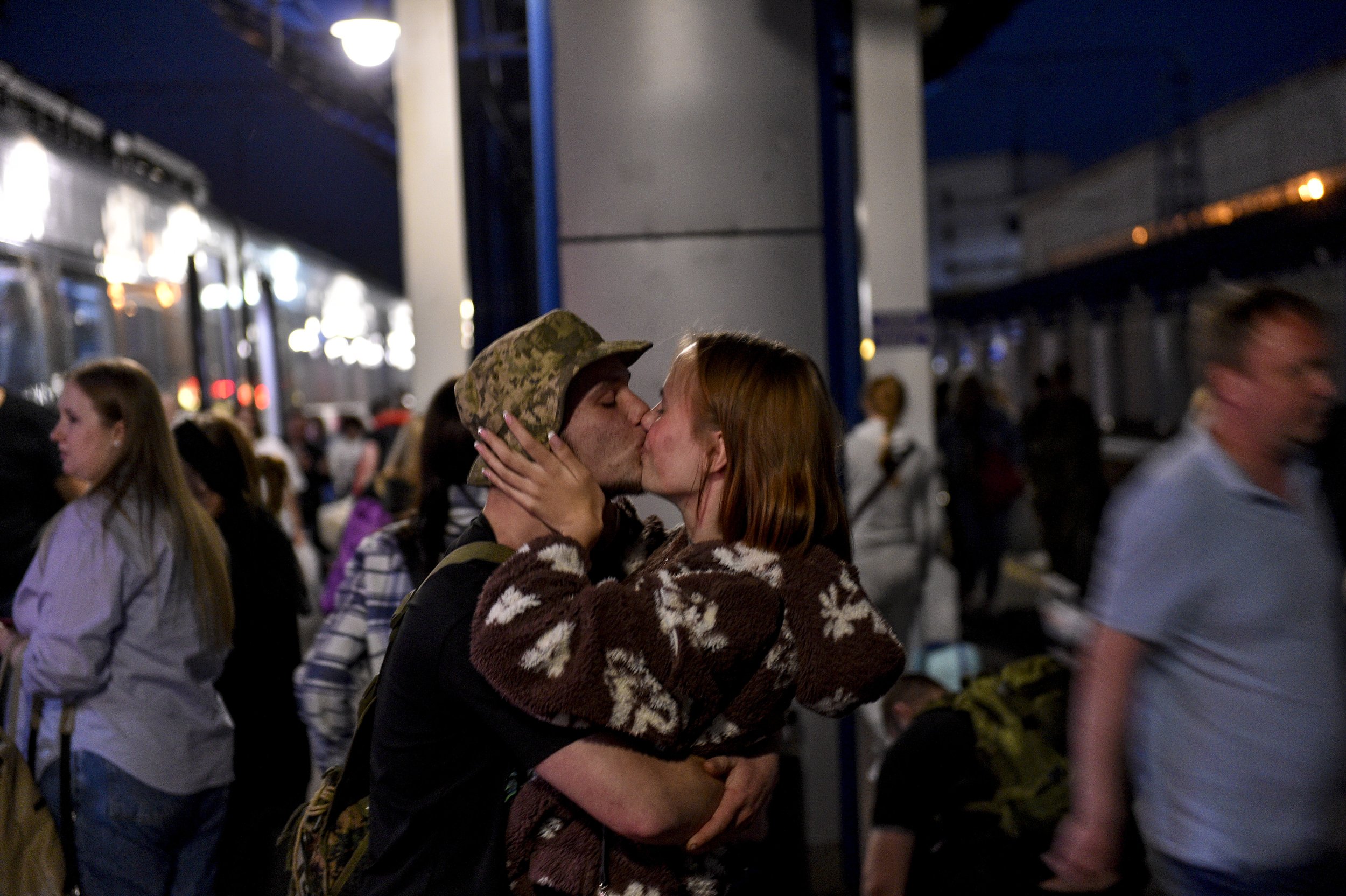  A young soldier returning to Kyiv from the frontline near Bakhmut kisses his girlfriend at the railway station on June 3, 2023. Across the country ordinary civilians find themselves caught up in the war. 