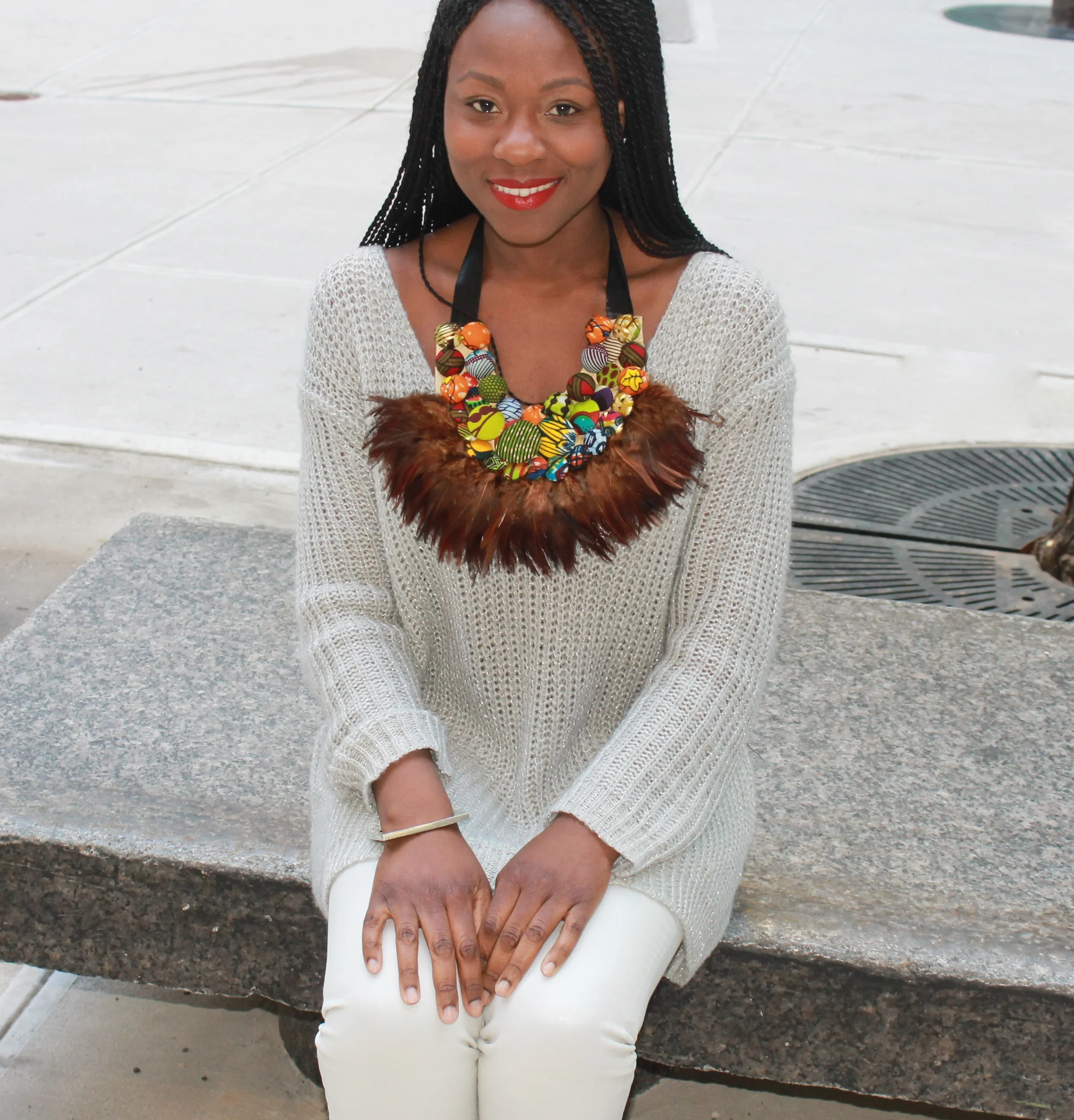 My motivation for this outfit was to find a balance between this wintery NYC weather and the springtime feel of this colorful ankara-covered button and feather neck piece. I started with the grey/silver crotchet sweater and decided to keep the entire look monochromatic by adding iridescent coated jeans, metallic Zara flats and a tin bangle by Indego Africa. What do you think of this look? Christie Brown Necklace - for shipping to US/UK place inquiries here: + 233 (0) 244 418477 or info@christiebrownonline.com. Similar available online here . In Ghana buy here: Christie Brown Studio 1st Osu Street Accra , Ghana In Nigeria here: Temple Muse No 21, Amodu Tijani Victoria Island Sweater - Old from Century 21 Shoes - A couple season back from Zara Bracelet, Indego Africa - Available singly at Nubian Hueman 1231 Good Hope Rd SE Washington DC, or in a set of three online here Thanks for visiting!