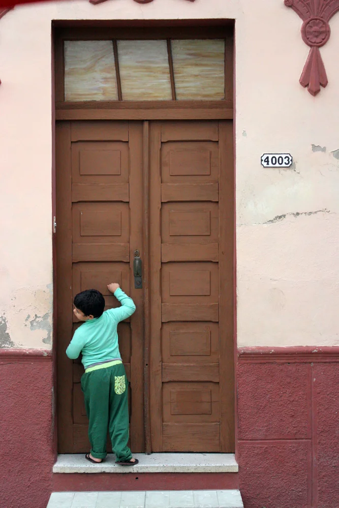 A boy knocking on a door.jpg