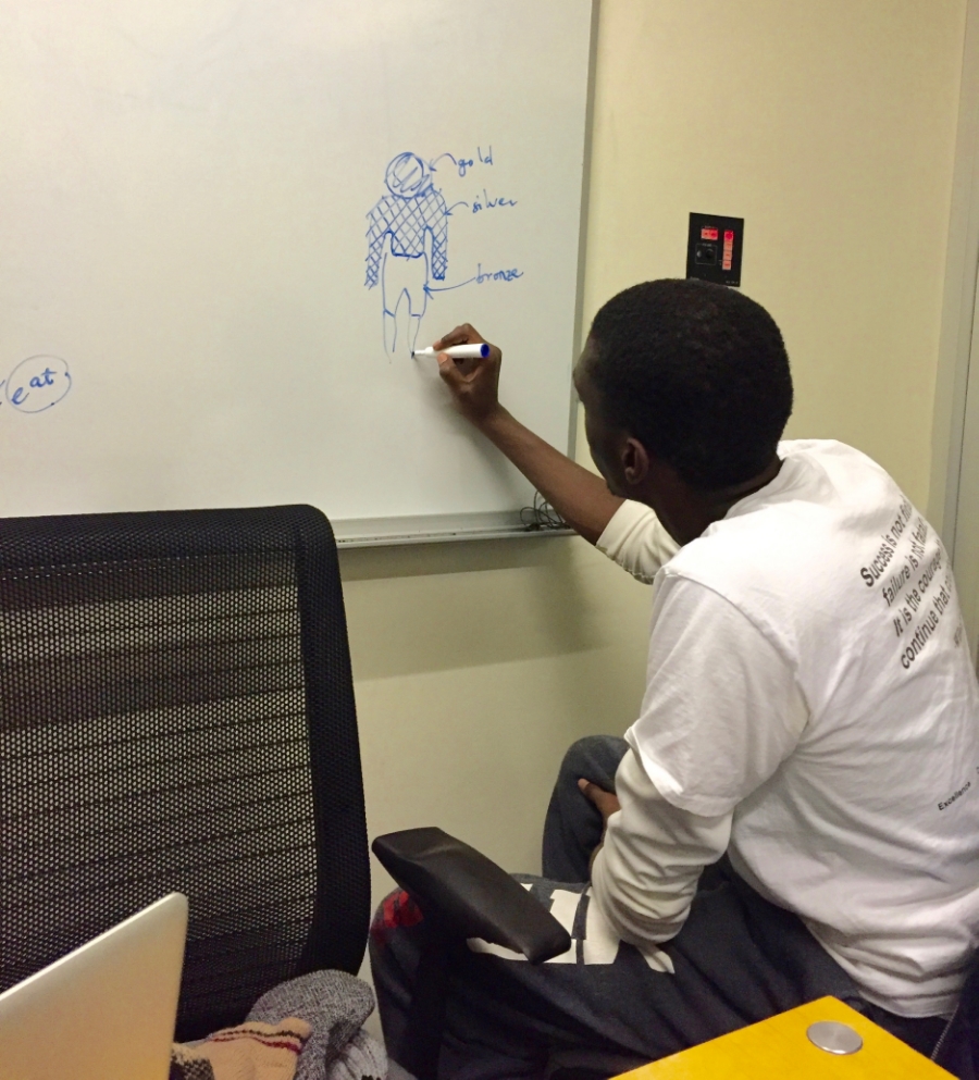 Kwabena drawing the statue in the vision of Daniel 2 during a study session.