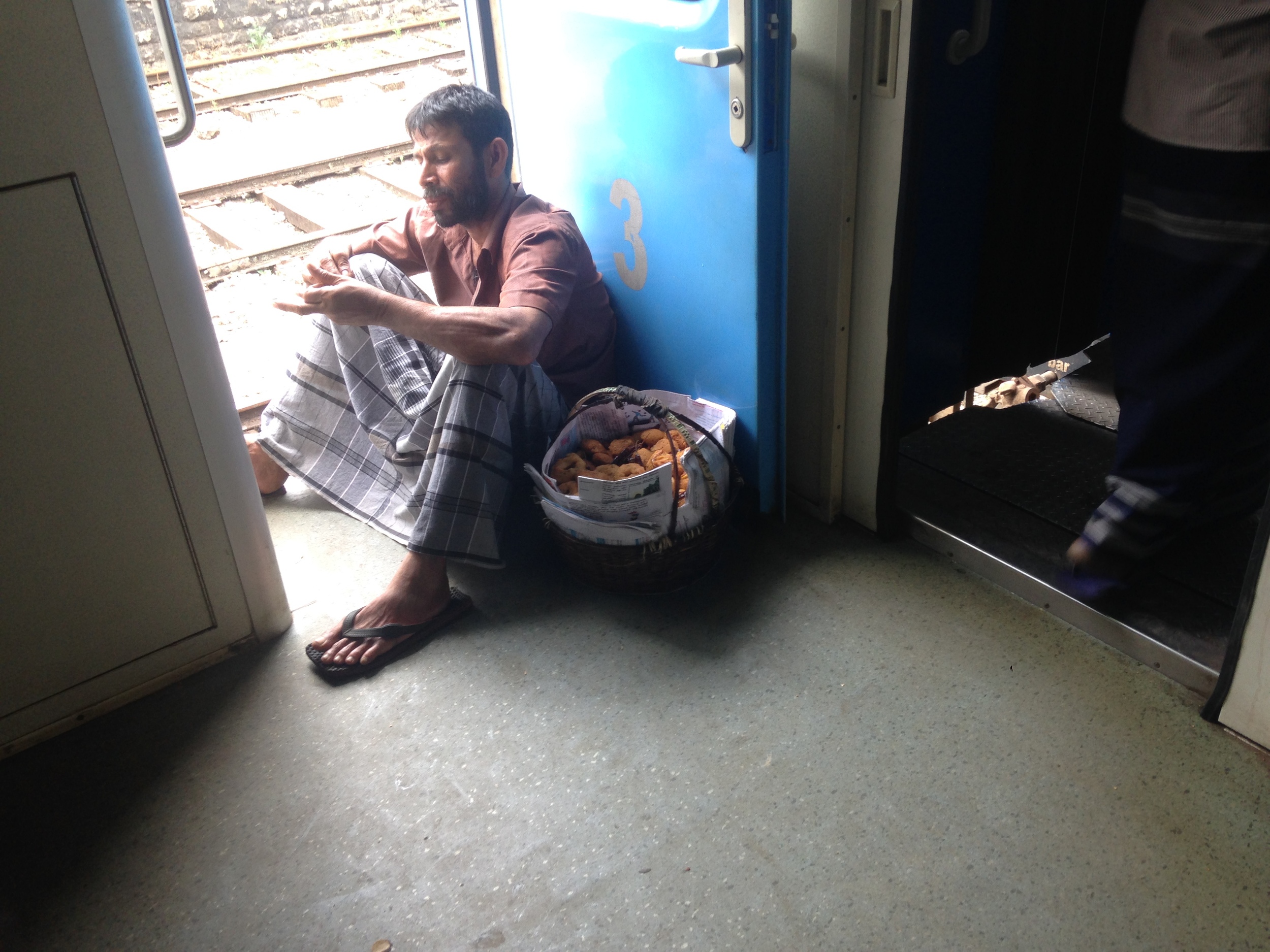  A vendor taking a break on the train. 