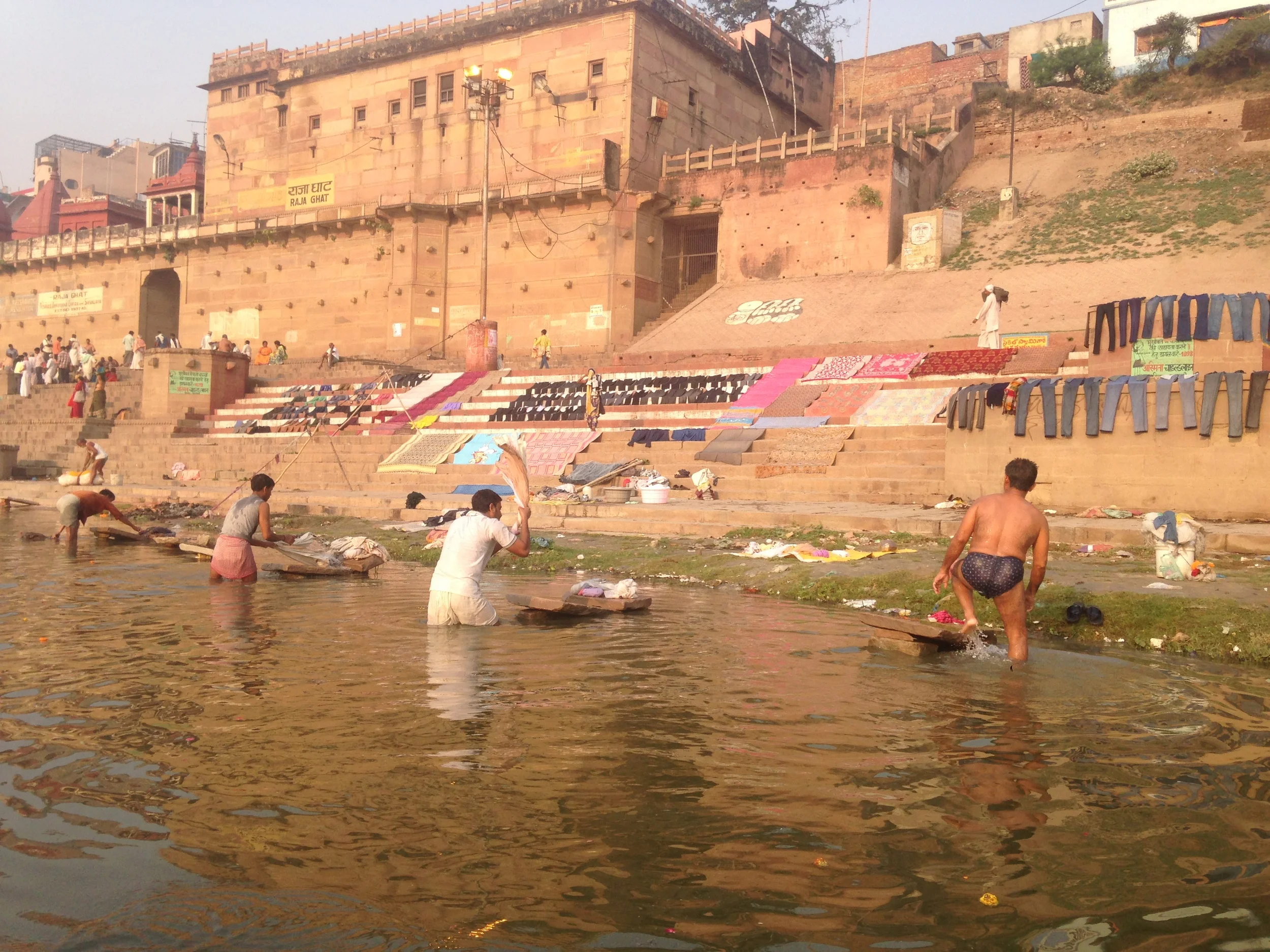 Whacking laundry across stone slabs and drying them in the morning sun.