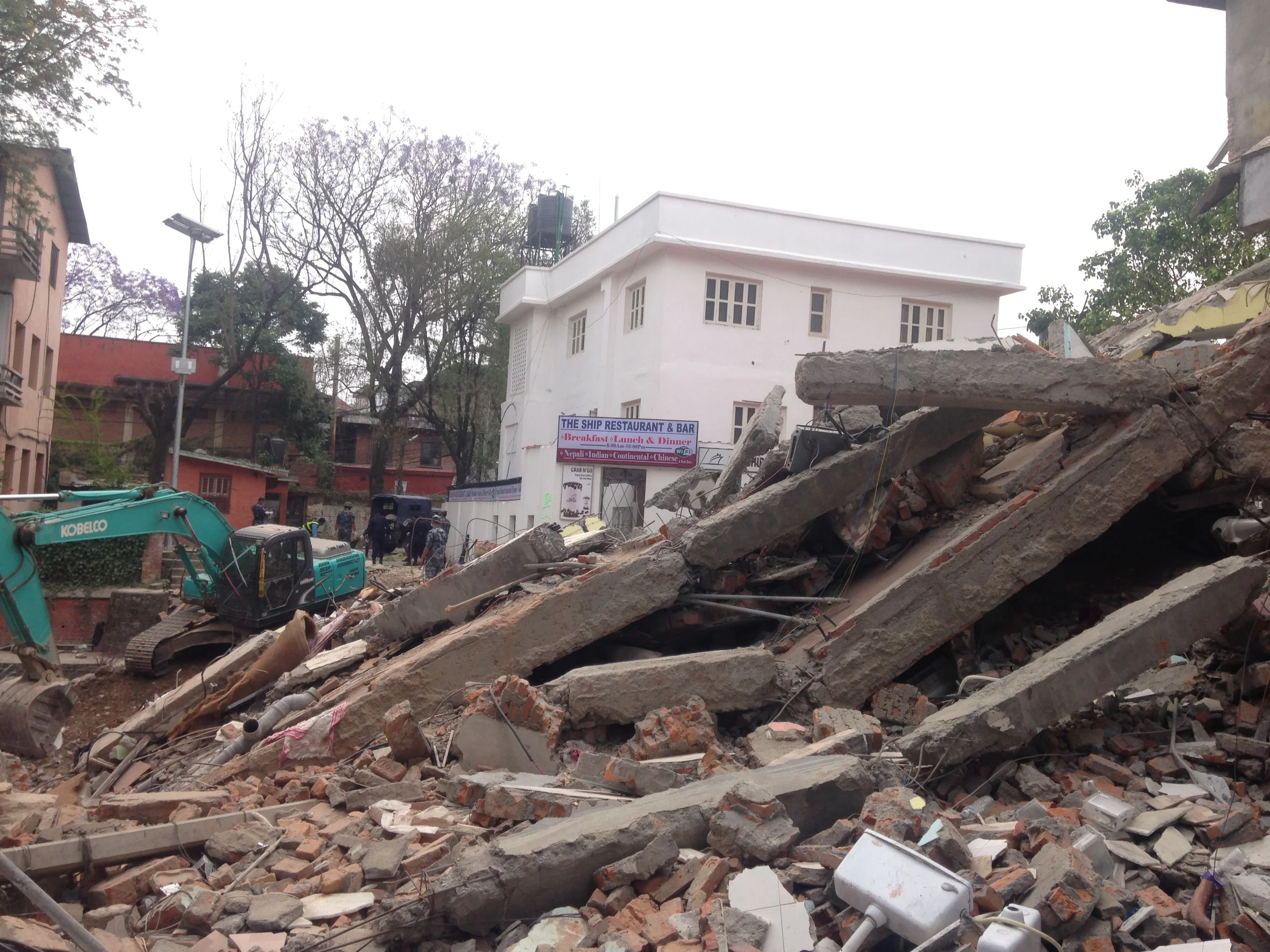 Down an alleyway in Thamel. Police in the background were loading bodies into the truck.
