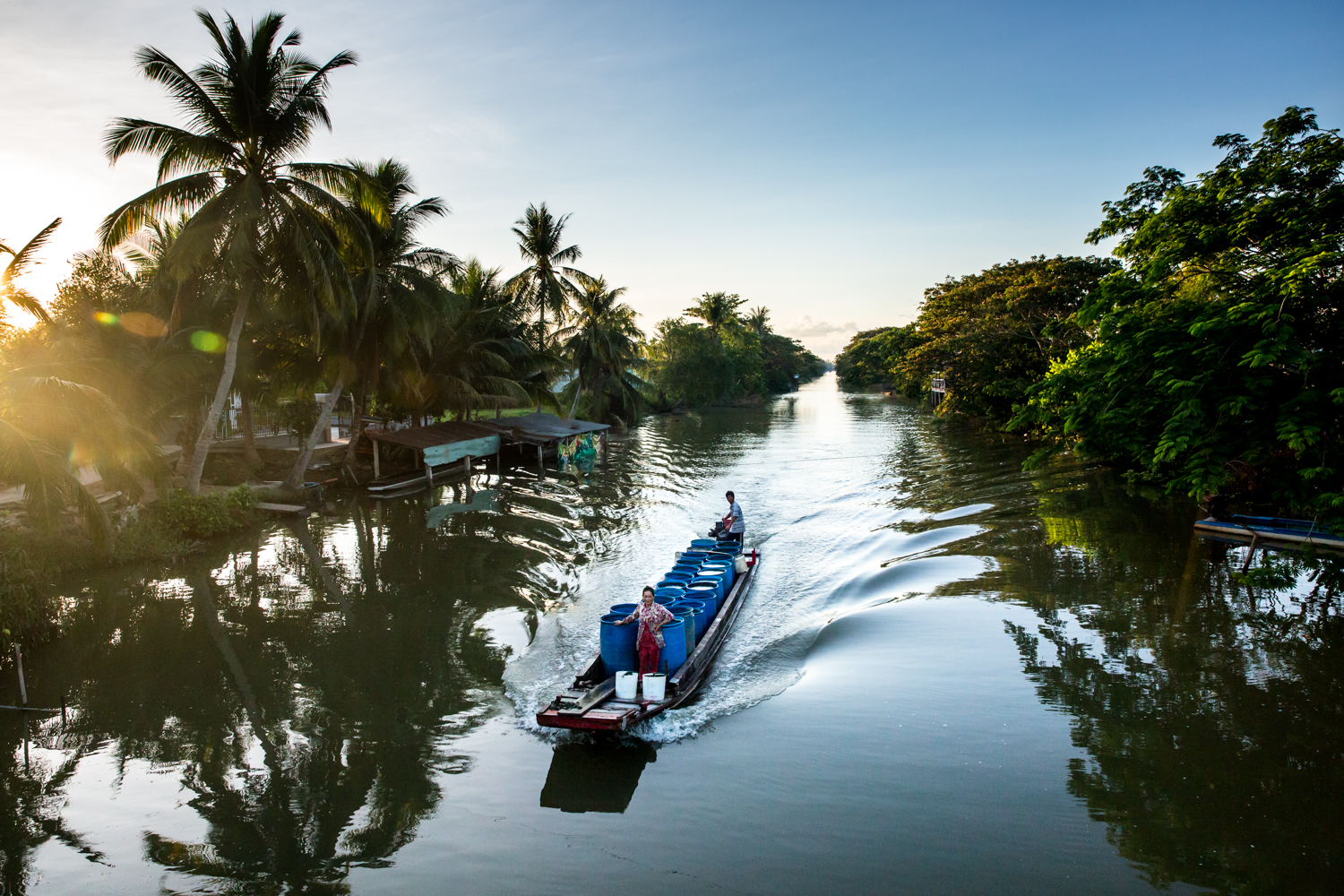  A boat full of barrels of water to be sold to drought ravaged farmers in Soc Trang, Mekong Delta, Vietnam. 