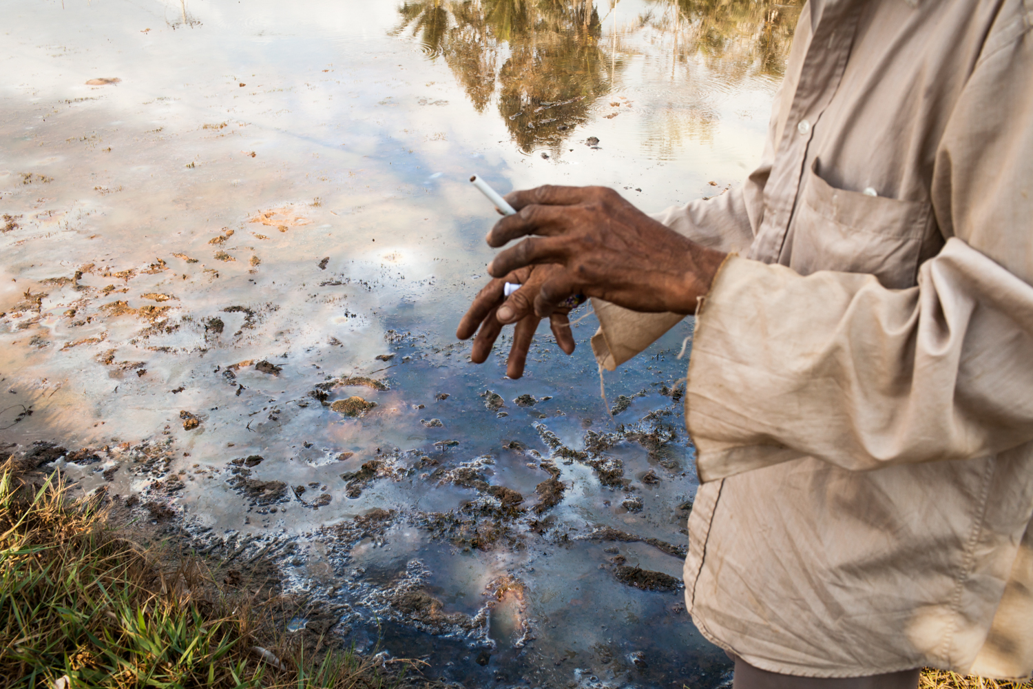  Nep, 69, looks at a test of his river water, which reads 25% saline. His shrimp farm is currently inoperable due to such high levels. 