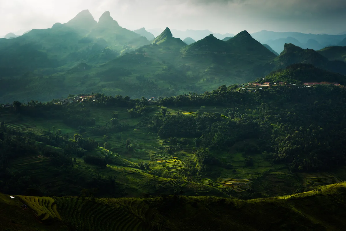 Taken on one of my many motorbike adventures in the mountains of Northern Vietnam. The weather hadn't been kind to me on this afternoon as I drove towards the town of Cao Son in Lao Cai District. Luckily I was in the right spot when the clouds did part, I halted my bike and with no time to grab my tripod I choose a fast shutter speed and hoped for the best as a few rays of sunshine dappled across the magnificent rice paddies below. Moments later the show was over and I went on my way. Canon 5D Mk III, 24-70mm f2.8L II lens at 50mm, 1/250 sec at f4, ISO 100.