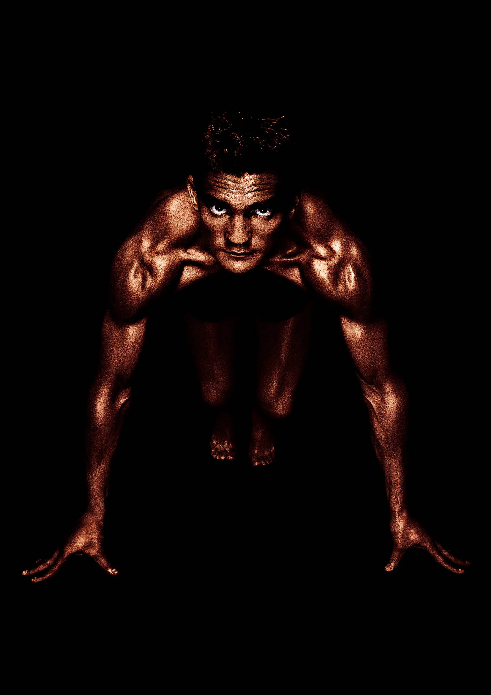  Portrait of muscular athlete in track stance. 