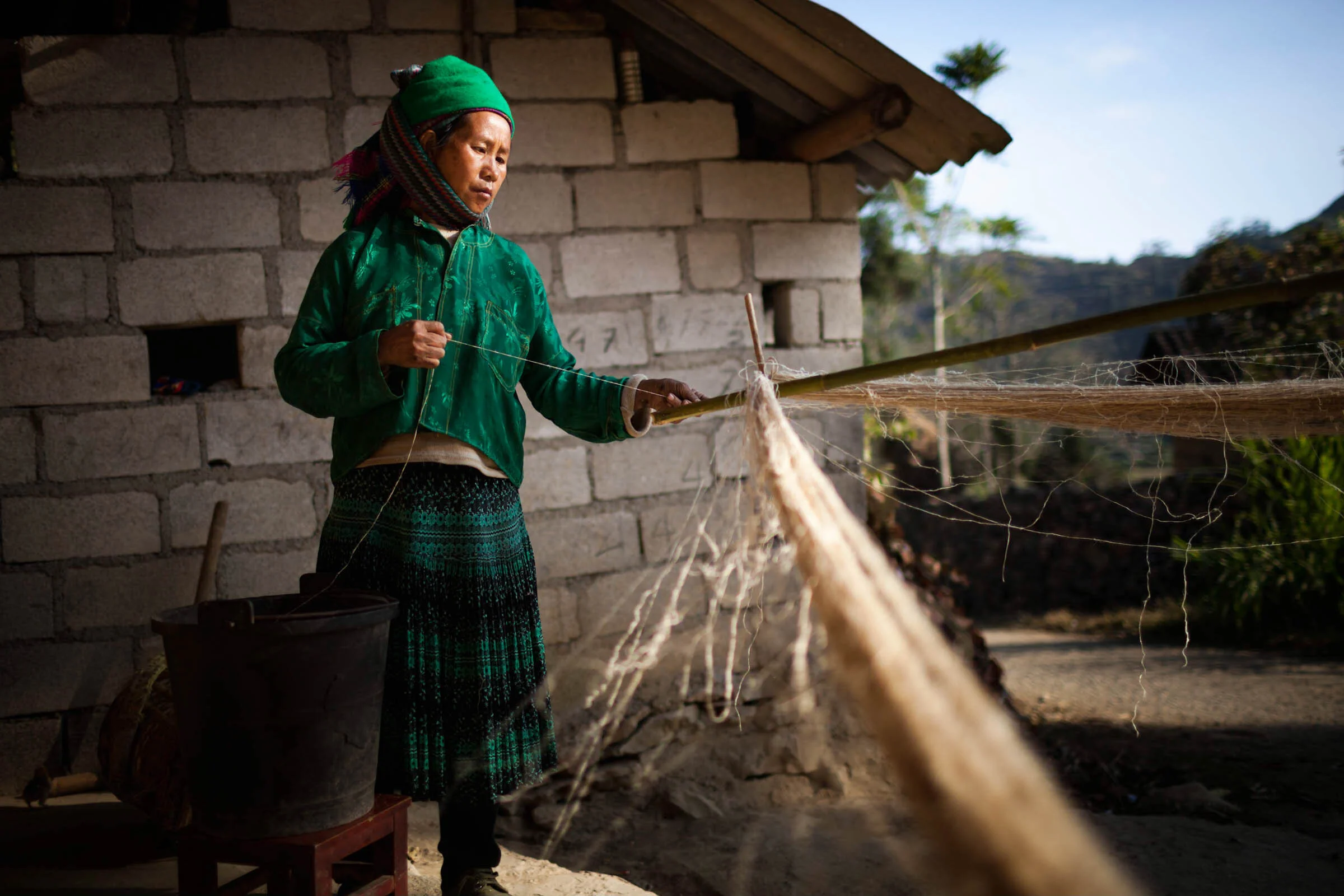  Woman winding linen strands in Lung Cu, Ha Giang, Vietnam. 