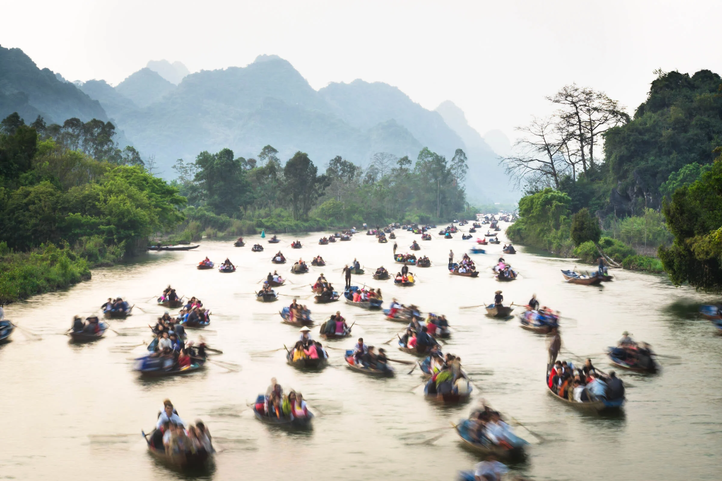  The busy Yen Vi river as boats paddle pilgrims back from a visit to the Perfume Pagoda (Huong Pagoda), Vietnam. 