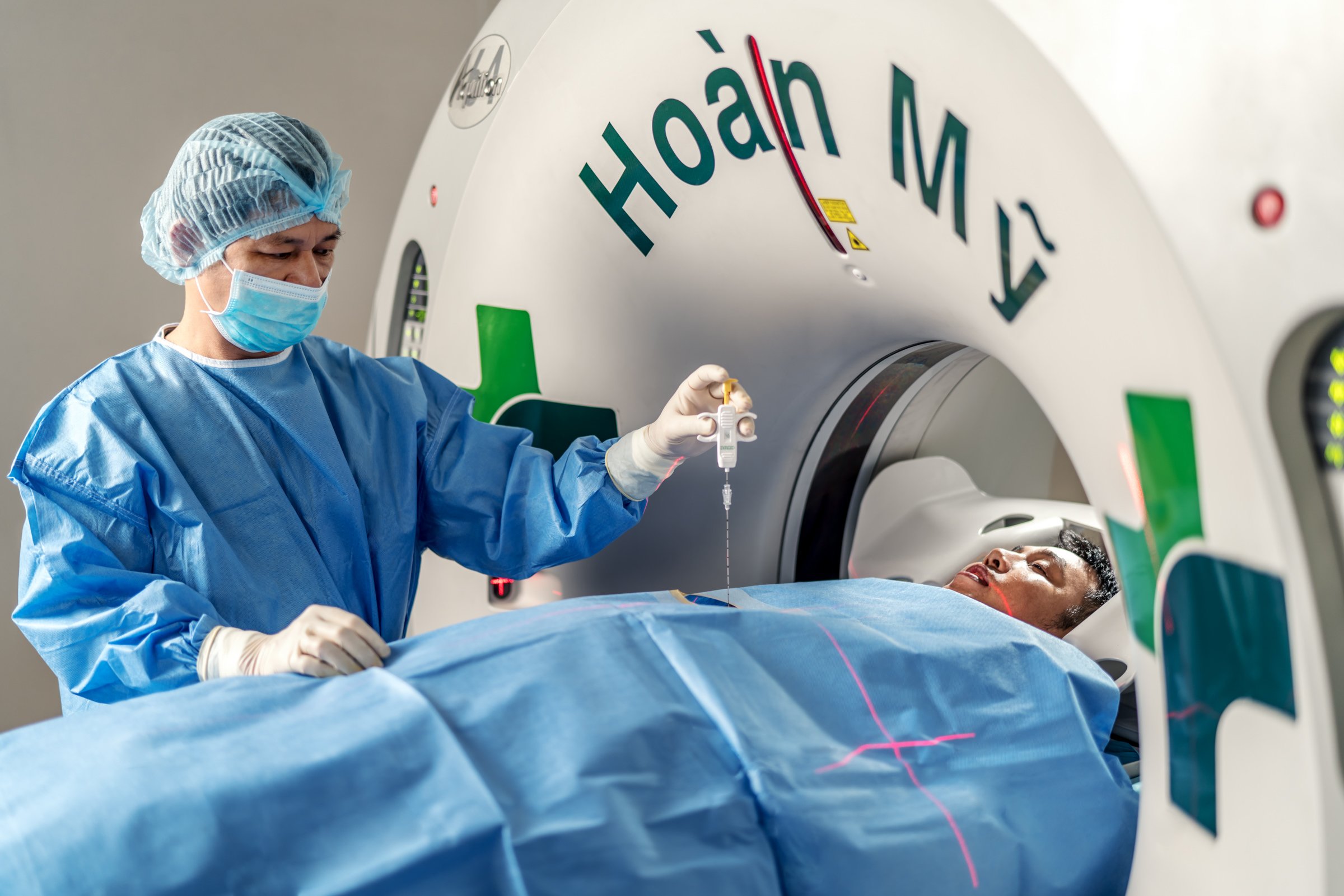 Doctor prepares patient before CT Scan.