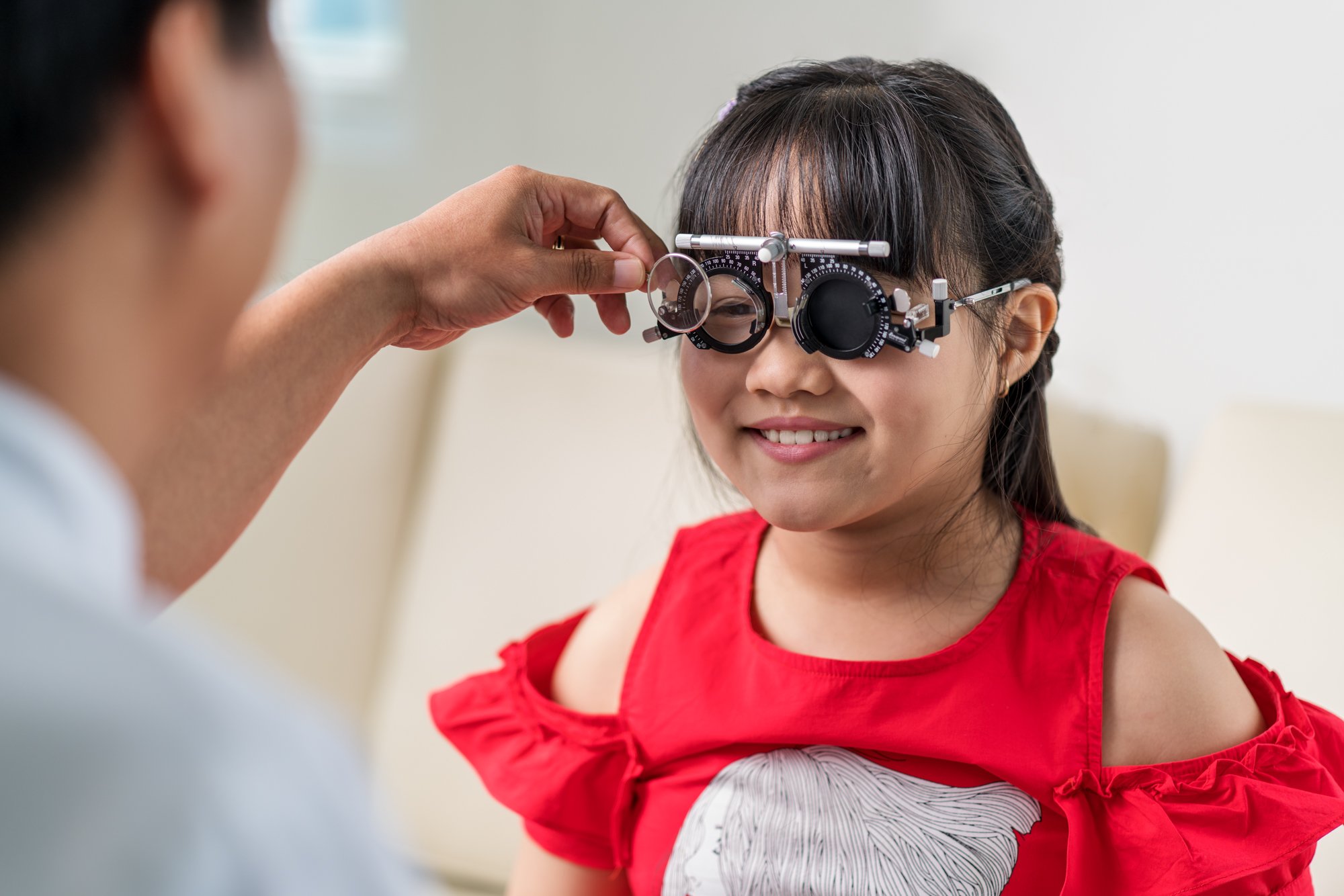 A Dr performs a Paediatric eye exam on young child at Hoan My Eye Hospital.
