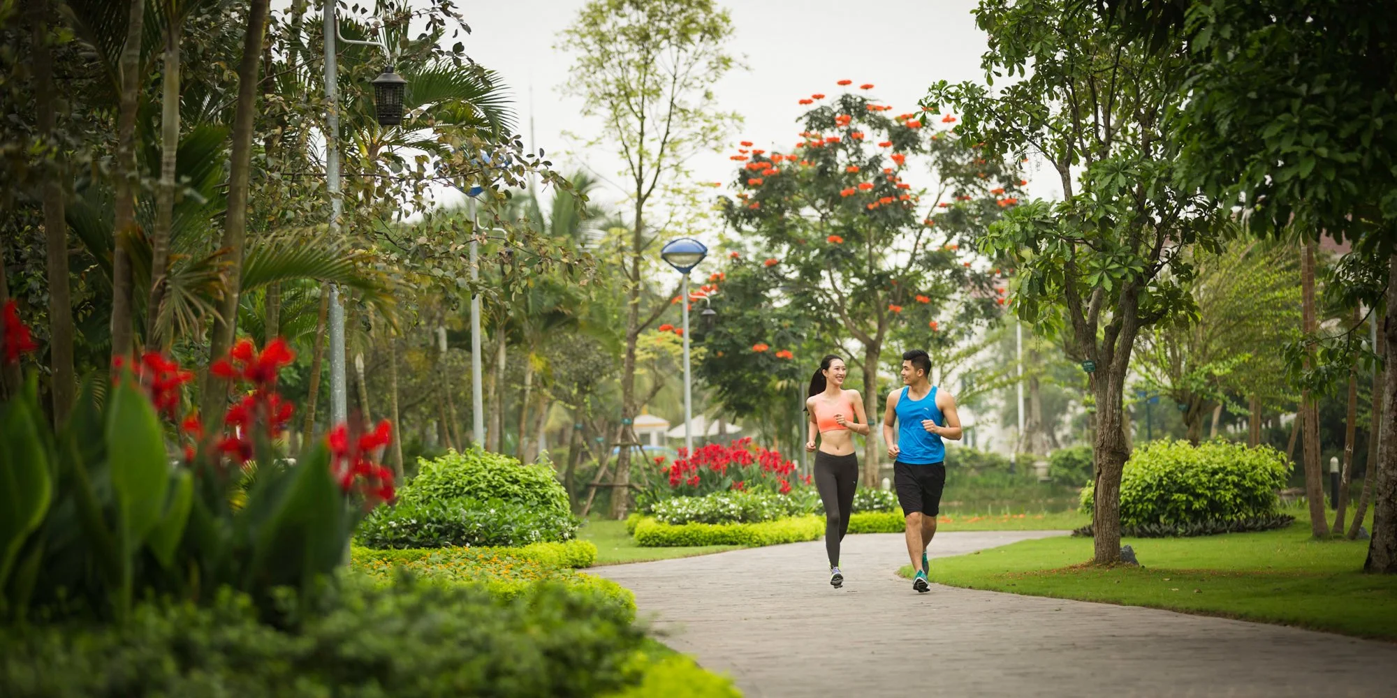  Fit female and male jogging in park at VinHomes Riverside, Hanoi. 