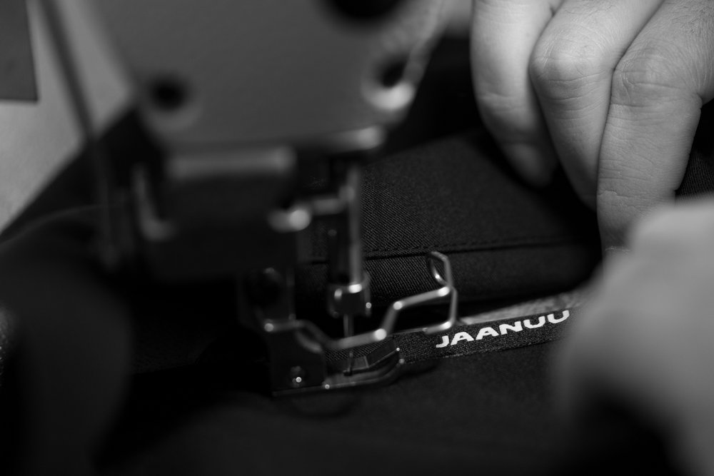 Detail as Jaanuu label is sewed onto textile design.