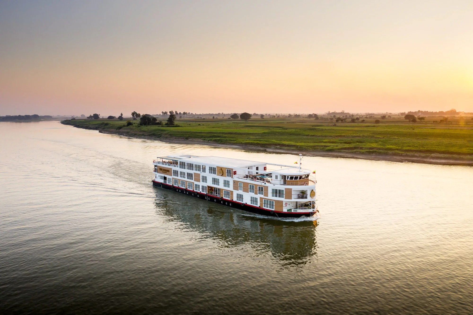  The Strand Cruise ship at sunset on the Irrawaddy River near Mandalay, Myanmar. 