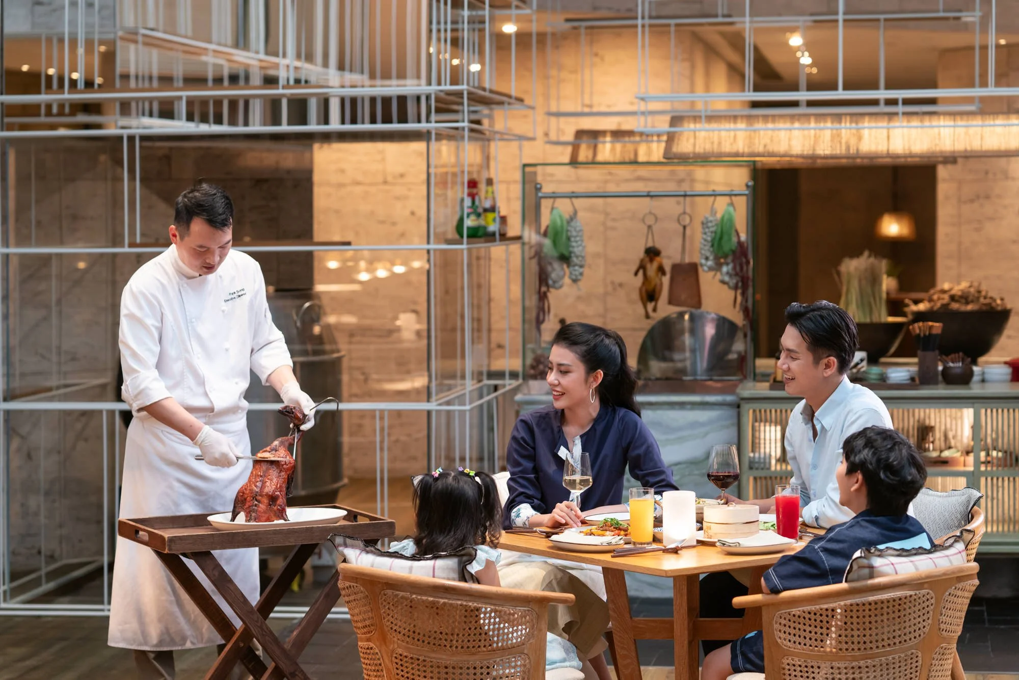  A family watch on as Blend Restaurant Chinese Chef carves Peking Duck tableside, New World Hoiana Beach Resort. 
