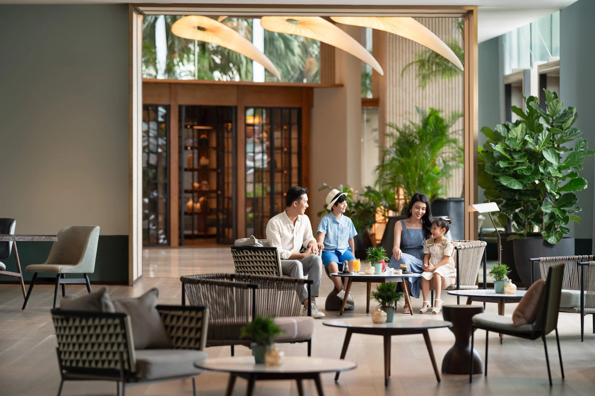  Family gather at the Common indoor seating area, New World Hoiana Beach Resort. 
