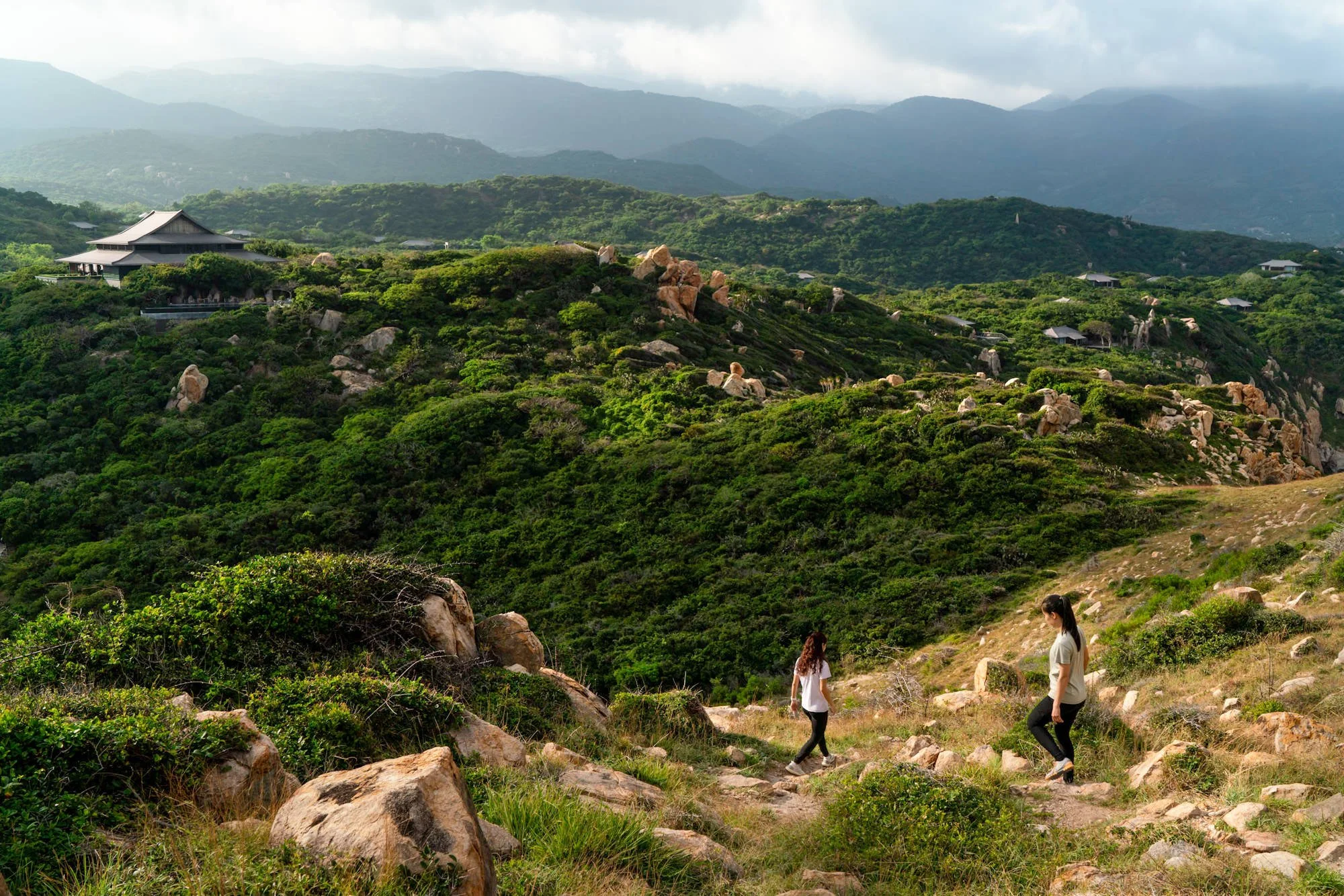  Women trek from the peak of Goga Peak with Amanoi reception in the background, Vinh Hy, Ninh Thuan, Vietnam 