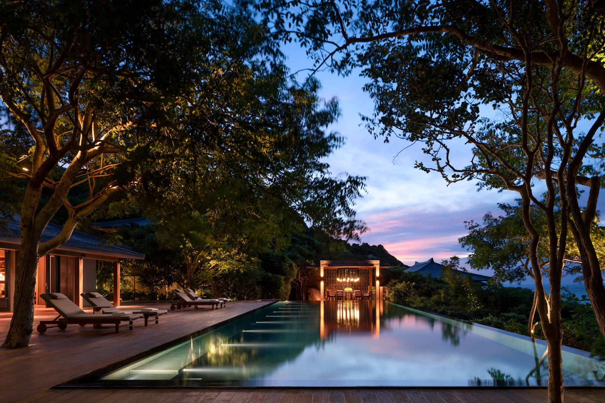  Amanoi residence pool, decking, deck chairs and dining pavilion at dawn. 