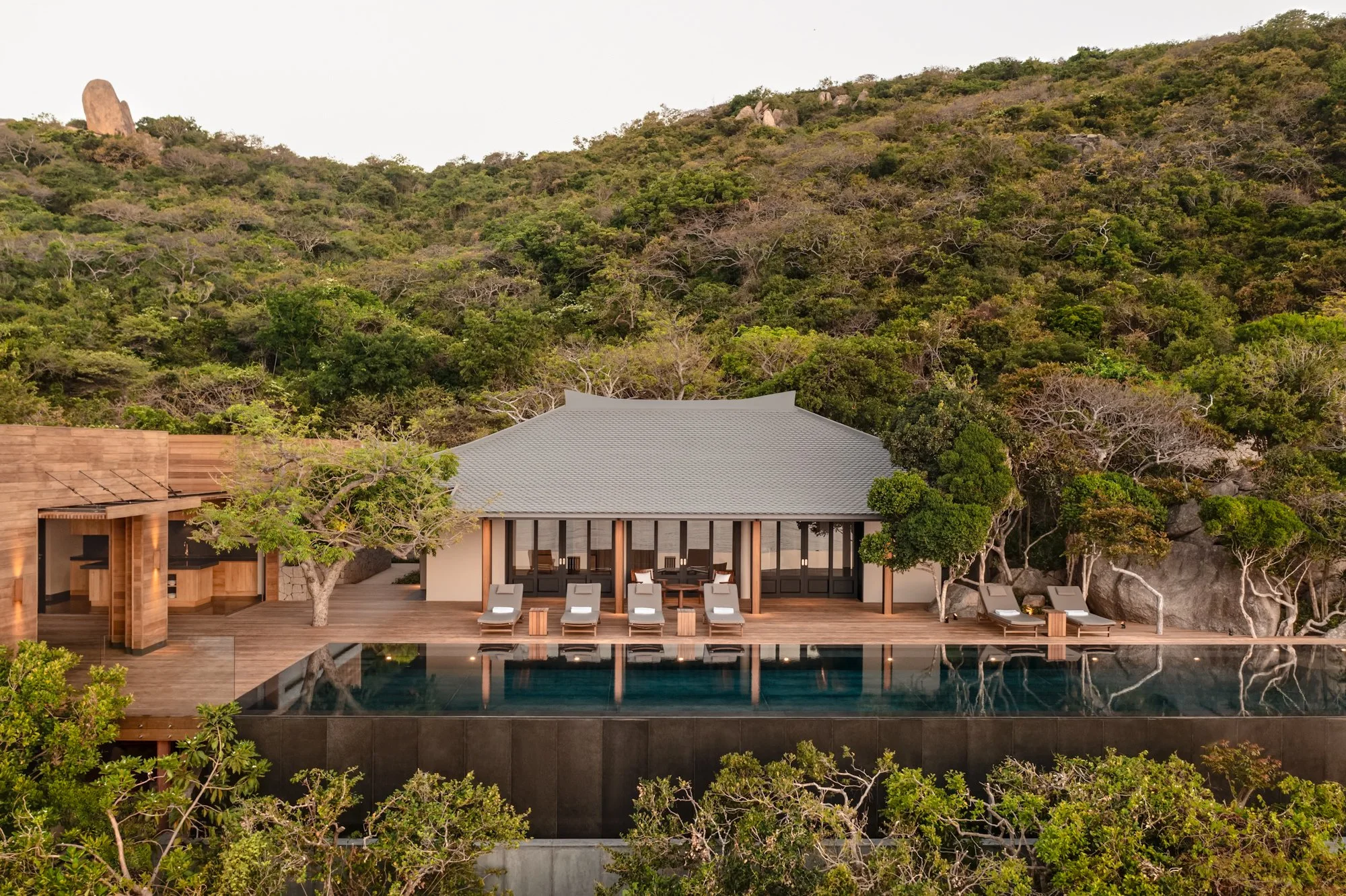  Amanoi Ocean Pool Residence with open-air kitchen and dining pavilion overlooking the infinity pool, ocean and surrounding forest. 