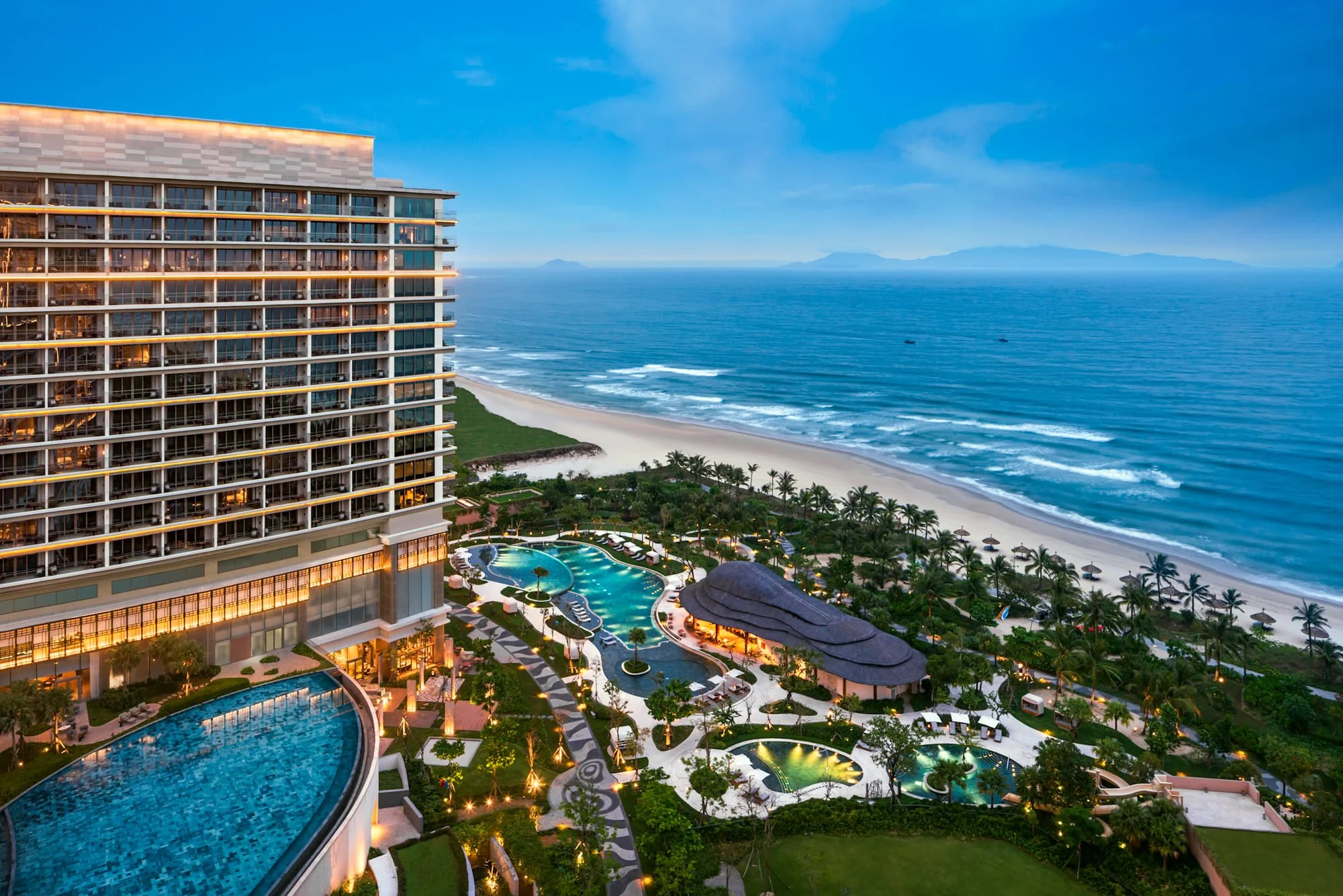  New World Hoiana Beach Resort overlooking the South China Sea, with the resort’s landscaped grounds, swimming pools and beachfront setting. 