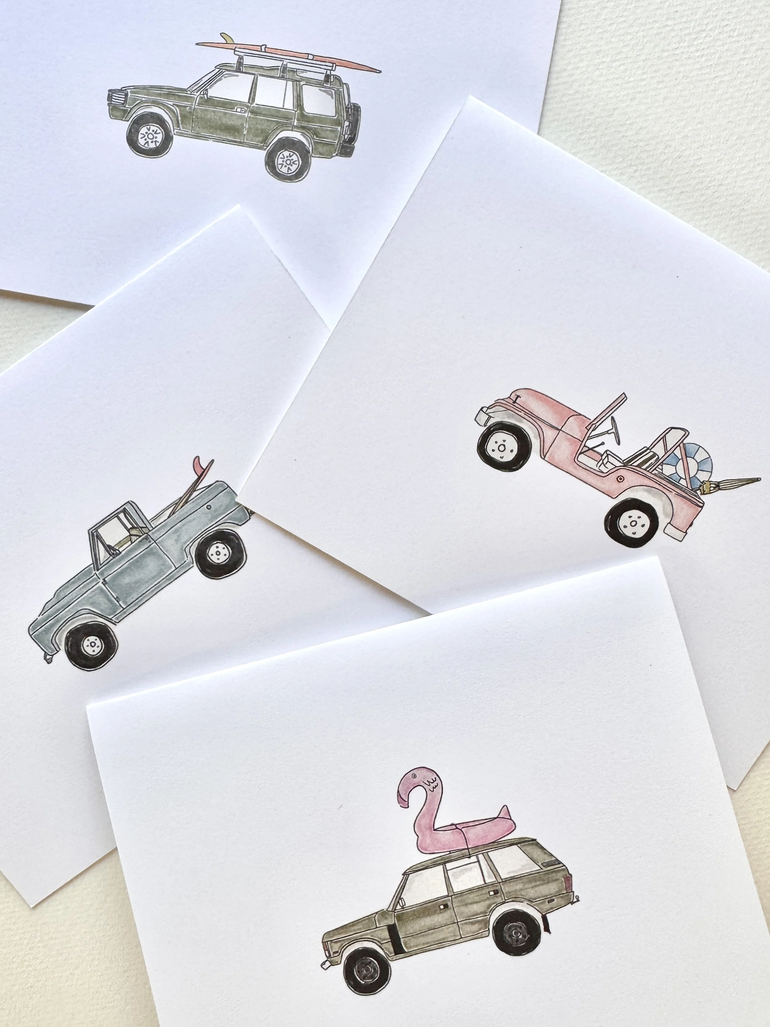 Illustrations by Susie Bettenhausen of beach trucks and cars with summer accessories like surfboards, flamingos, and pool inflatables in print and notecard forms of stationery.