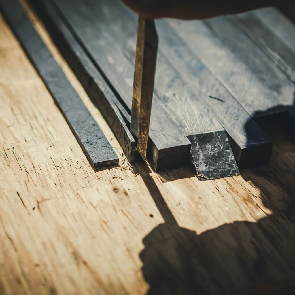   Slate-ish  in the making! Scraps of Richlite and Paperstone laminate countertop are split along the layers to reveal a riven stone texture. This stuff is so strong... 
