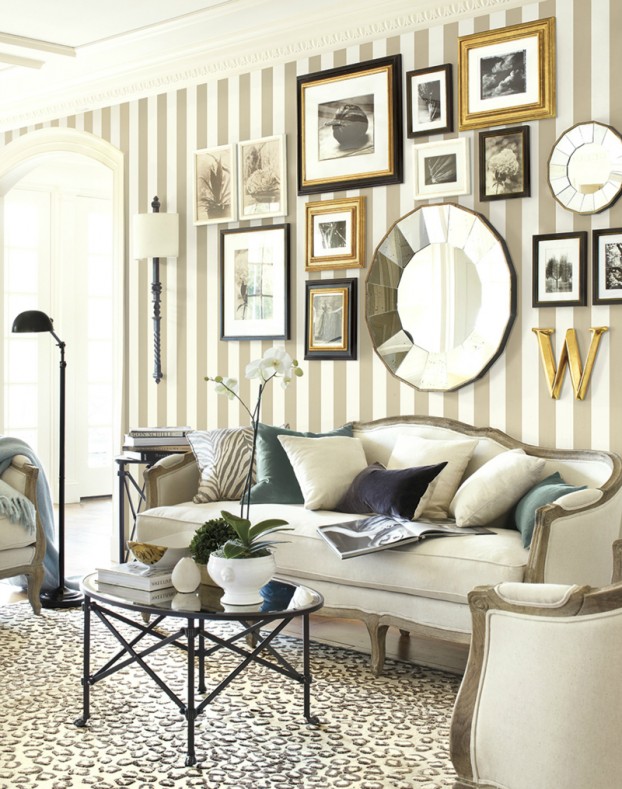 This is a rather fancy display, but it uses a perfect balance of finishes/hues (black/gray, white/silver, gold/brass). The content is cohesive and the pieces are nicely spaced and proportionate to the wall and furniture.