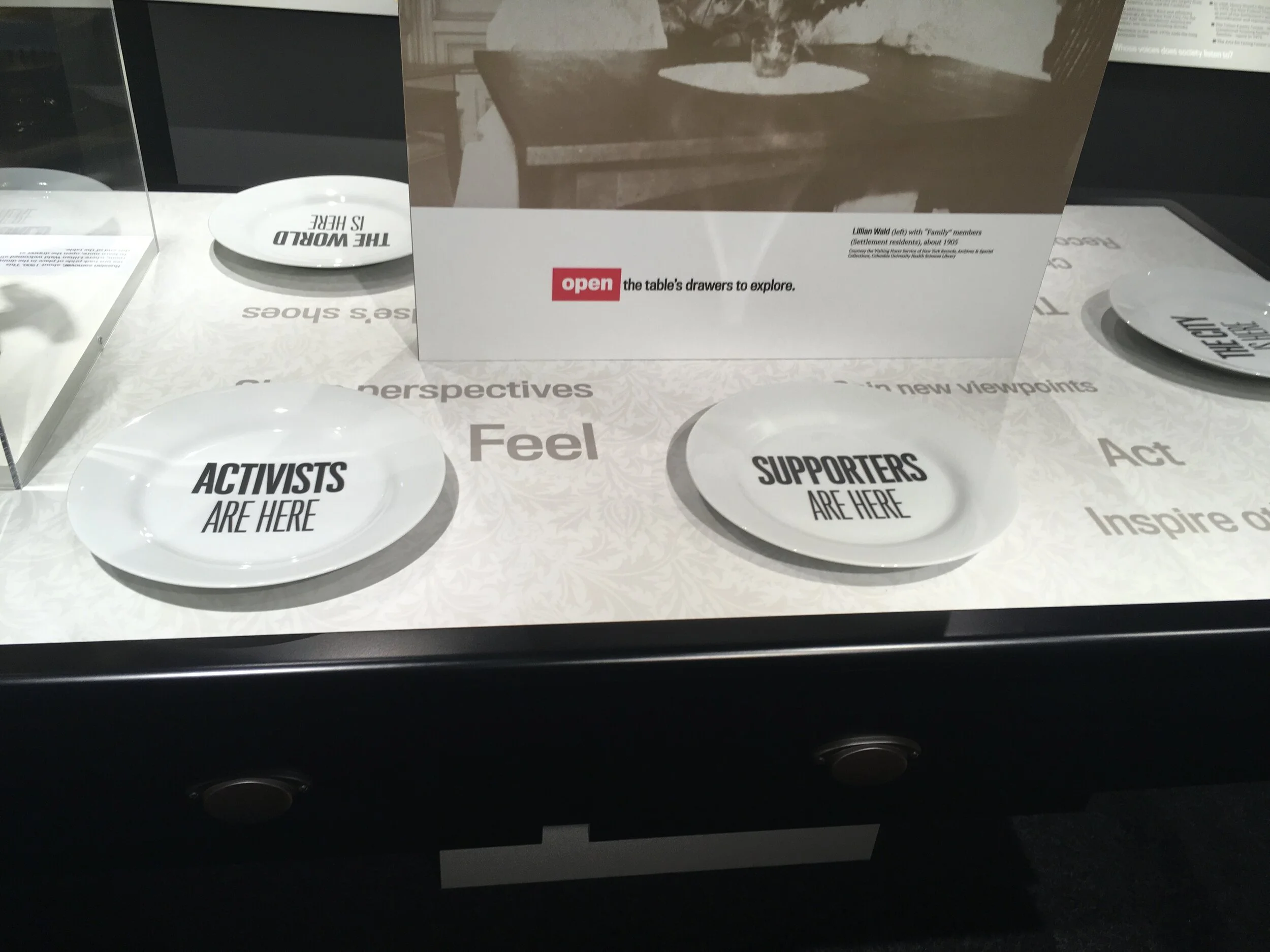 Pullout drawers in the table let visitors explore more about Henry Street's culture of activism and connection.